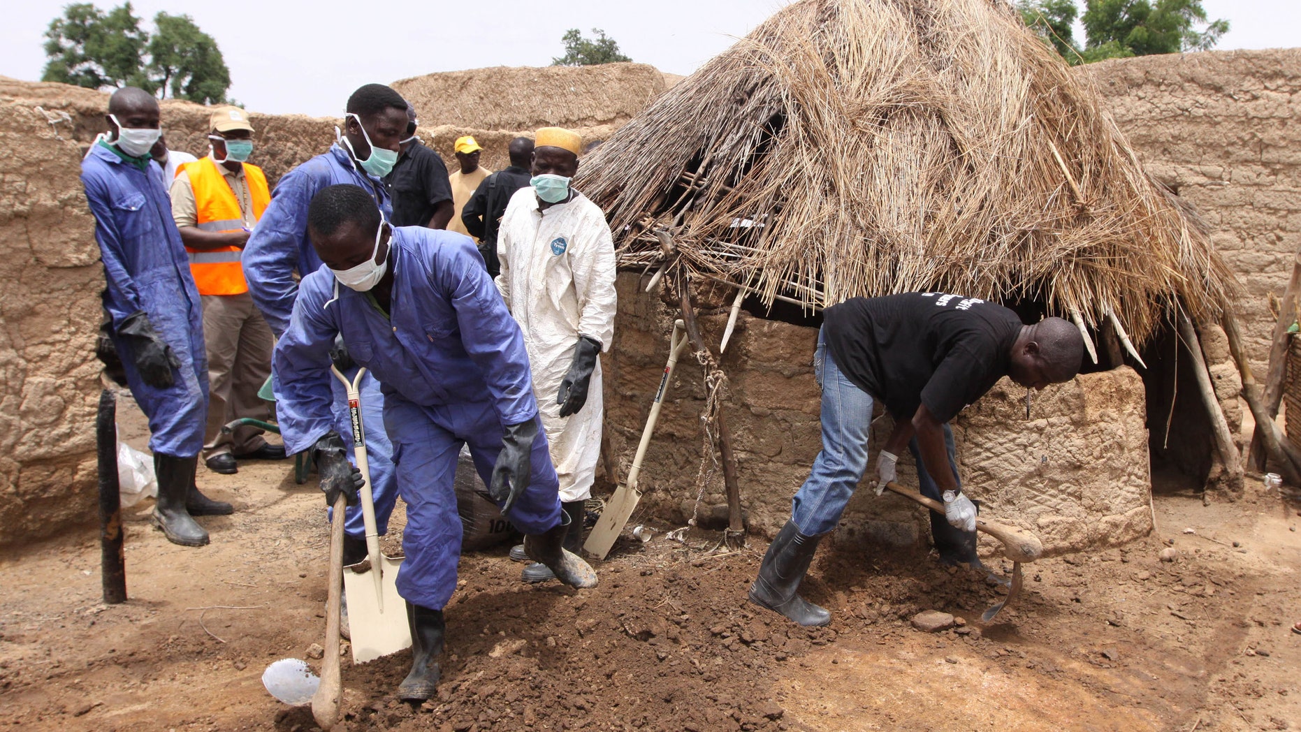 Local health workers removing earth contaminated by lead from a family compound in the village of Dareta in Gusau, Nigeria.