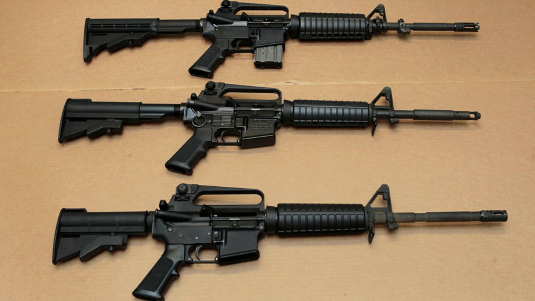 FILE -- In this Aug. 15, 2012 file photo, three variations of the AR-15 assault rifle are displayed at the California Department of Justice in Sacramento, Calif. While the guns look similar, the bottom version is illegal in California because of its quick reload capabilities. Omar Mateen used an AR-15 that he purchased legally when he killed 49 people in an Orlando nightclub over the weekend President Barack Obama and other gun control advocates have repeatedly called for reinstating a federal ban on semi-automatic assault weapons that expired in 2004, but have been thwarted by Republicans in Congress. (AP Photo/Rich Pedroncelli,file)