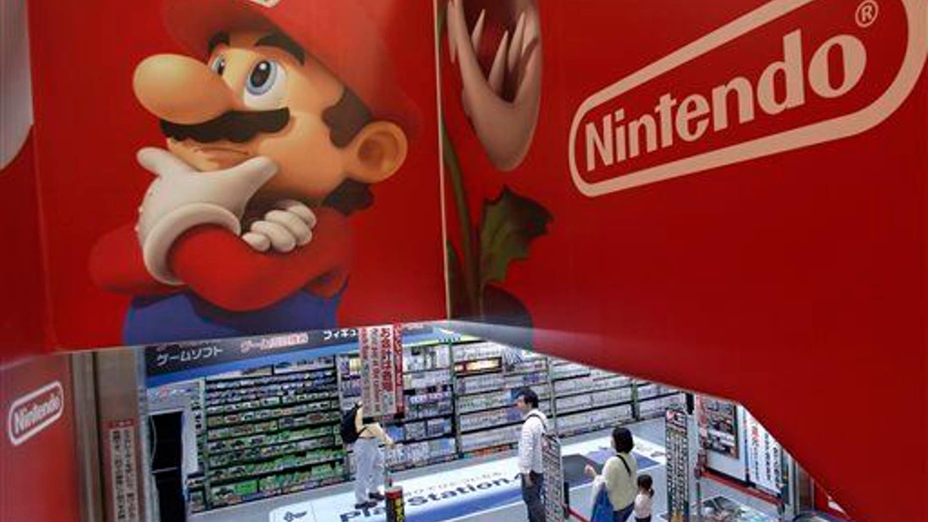 Shoppers walk under the logo of Nintendo and Super Mario characters at an electronics store in Tokyo.