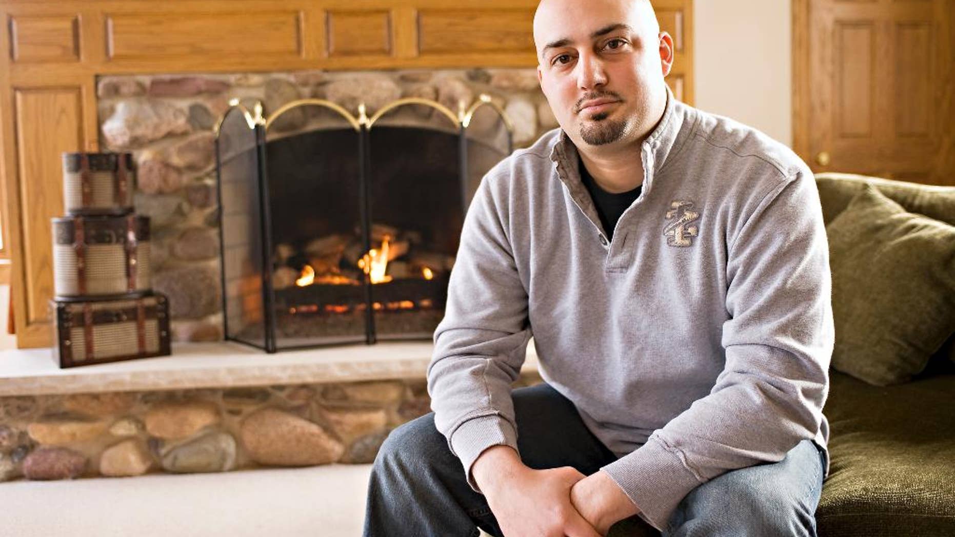 This photo taken in 2011 shows Abe Mashal posing for a photo at his home in St. Charles, Ill. The Obama administration is promising to change the way travelers can ask to be removed from its no-fly list of suspected terrorists banned from air travel. One of the plaintiffs in the Portland lawsuit, Abe Mashal, was unable to print his boarding pass before a flight out of Chicago four years ago. A counter representative told him he was on the no-fly list and would not be allowed to board. Mashal was surrounded by about 30 law enforcement officials, he said. (AP Photo/Sun-Times Media) MANDATORY CREDIT, MAGS OUT,