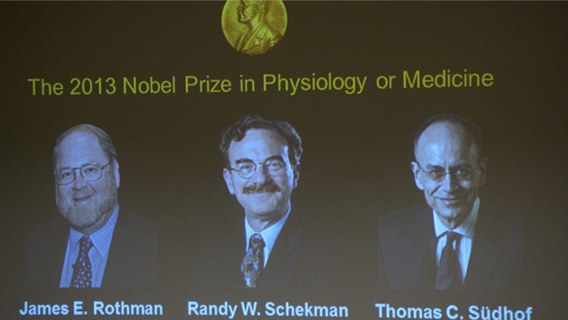 October 7, 2013: Images of James Rothman and Randy Schekman, of the US, and German-born researcher Thomas Suedhof are projected on a screen, in Stockholm, Sweden, Monday after they were announced as the winners of the 2013 Nobel Prize in medicine. (AP Photo)