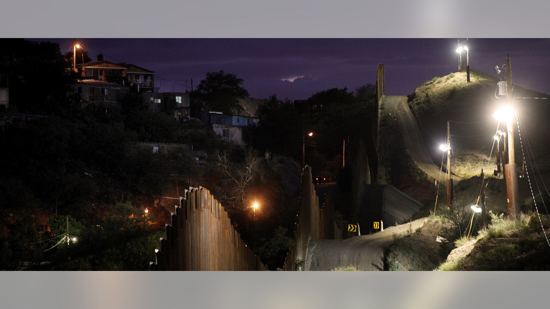 NOGALES, AZ - JULY 6: The border wall is illuminated at night July 6, 2012 in Nogales, Arizona. The president-elect of Mexico, Enrique Peña Nieto, stated that he wants to expand his country's drug-war partnership with the United States but that he would not support the presence of armed American agents in Mexico. (Photo by Sandy Huffaker/Getty Images)