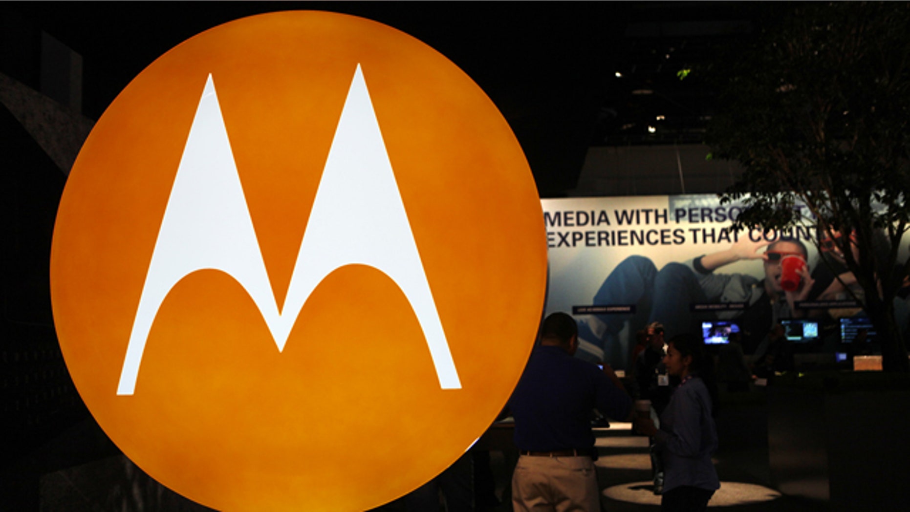 The Motorola logo is seen at the company's exhibit at the Consumer Electronics Show in Las Vegas. Motorola Inc. said Monday, July 19, 2010, that it is selling most of its wireless network division to Nokia Siemens Networks, a Finnish-German joint venture, for $1.2 billion as part of a planned breakup of the company.