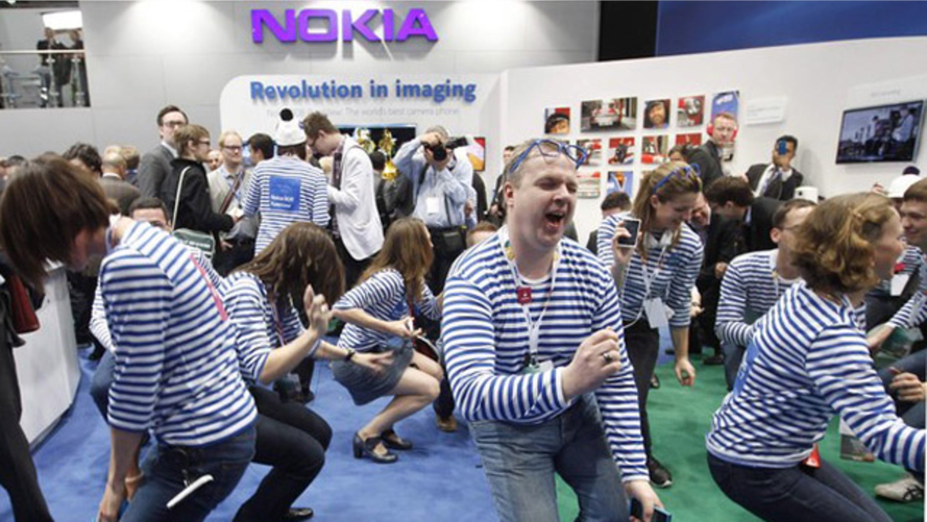 Feb. 27, 2012: Nokia staff dance after the presentation of the new Lumia 900 after a news conference during the Mobile World Congress in Barcelona.