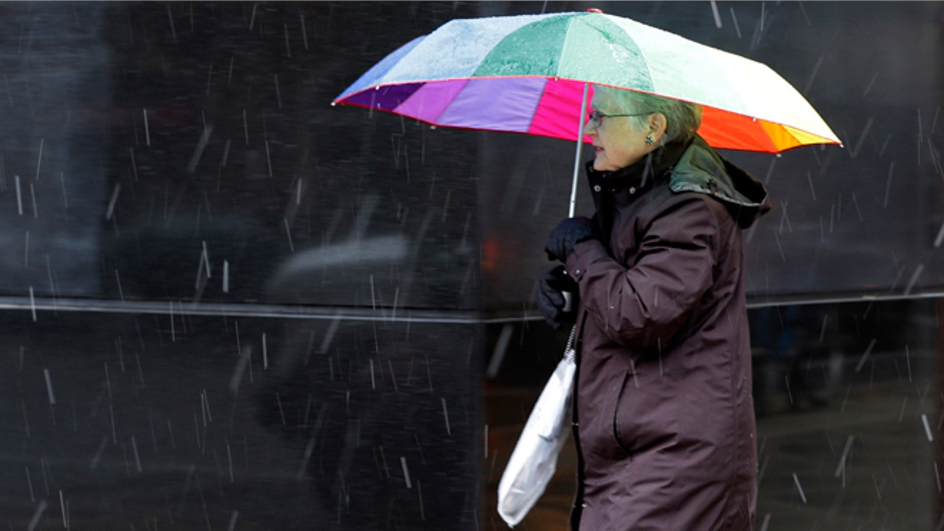 Nov. 7, 2012: A pedestrian walks along Broad Street through a nor'easter in Philadelphia. The storm was expected to bring a combination of wind-blown snow, sleet and freezing rain to eastern Pennsylvania later Wednesday and into Thursday morning, with snow accumulations of 3 to 5 inches possible, the National Weather Service said.
