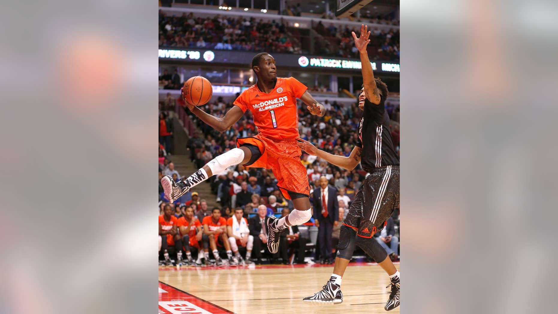 FILE - In this April 2, 2014, file photo, McDonald's East All-American Theo Pinson, left, saves the ball from going out-of-bounds as McDonald's West All-American Kelly Oubre defends during the second half of the McDonald's All-American boy's basketball game in Chicago. The 6-foot-6 Pinson arrived in Chapel Hill this summer and will help fill the Tar Heels' need for guard depth. (AP Photo/Charles Rex Arbogast, File)