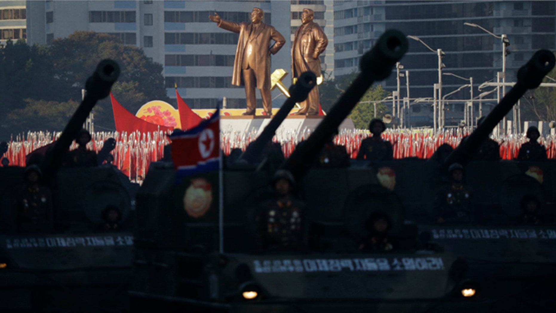 Oct. 10, 2015: Statues of Kim Il Sung and Kim Jong Il stand above soldiers during a military parade in Pyongyang, North Korea. (AP Photo/Wong Maye-E)