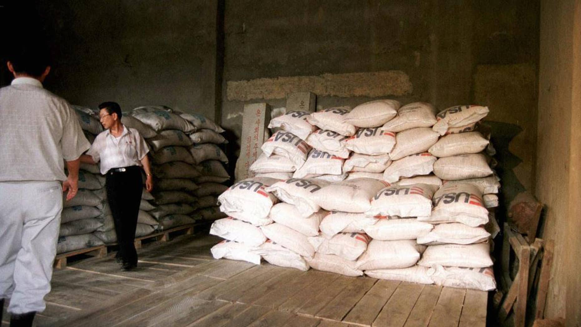 FILE - this June 26, 1997 file photo shows bags of cereal provided by the UN world food program at a corner of an almost empty warehouse used as a food storage in Hui Chon County, 200 kilometers (125 miles) northwest of Pyongyang. The U.N. agency that has provided food aid to North Korea for nearly two decades says it has enough donations to stay open for the rest of this year but is uncertain whether it will be able to operate there beyond next March. (AP Photo/UN, James Bu)