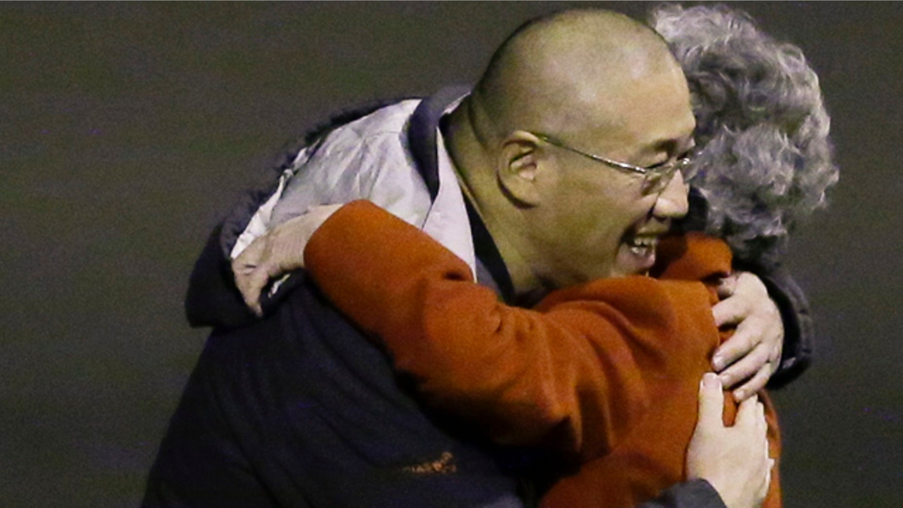 November 8, 2014: Kenneth Bae, left, who had been held in North Korea since 2012, hugs his mother Myunghee Bae after arriving at Joint Base Lewis-McChord, Wash., after being freed during a top-secret mission by James Clapper, U.S. director of national intelligence. (AP Photo/Ted S. Warren)