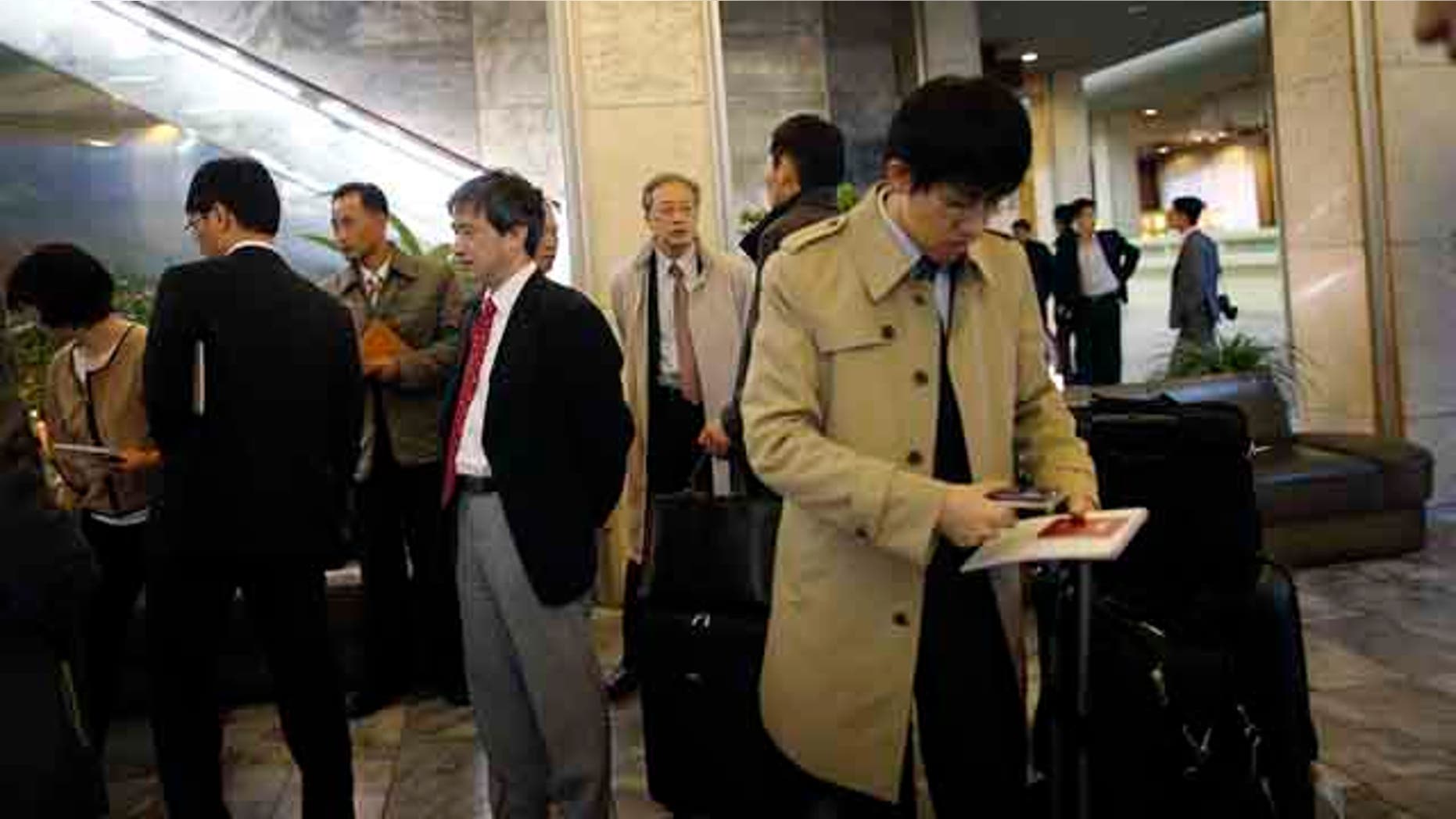 October 27, 2014: Junichi Ihara, director general of the Asia and Oceania affairs bureau of Japanese Foreign Ministry, center, waits in the lobby of the Koryo Hotel with the rest of the Japanese delegation in Pyongyang, North Korea. (AP Photo/Wong Maye-E)