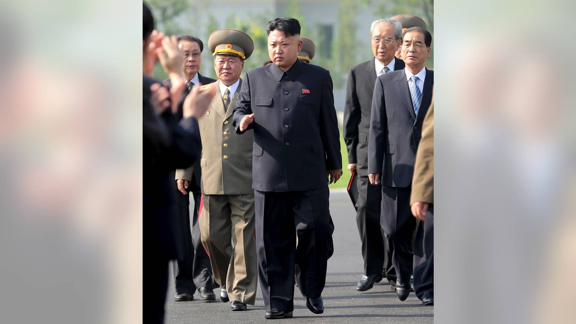 July 25, 2013: In this file photo, North Korean leader Kim Jong Un, center, arrives at the cemeteries of fallen fighters of the Korean People's Army (KPA) in Pyongyang, North Korea. South Korea's spy agency says it has an explanation of North Korean leader Kim Jong Un's mysterious 6-week-long public absence.
