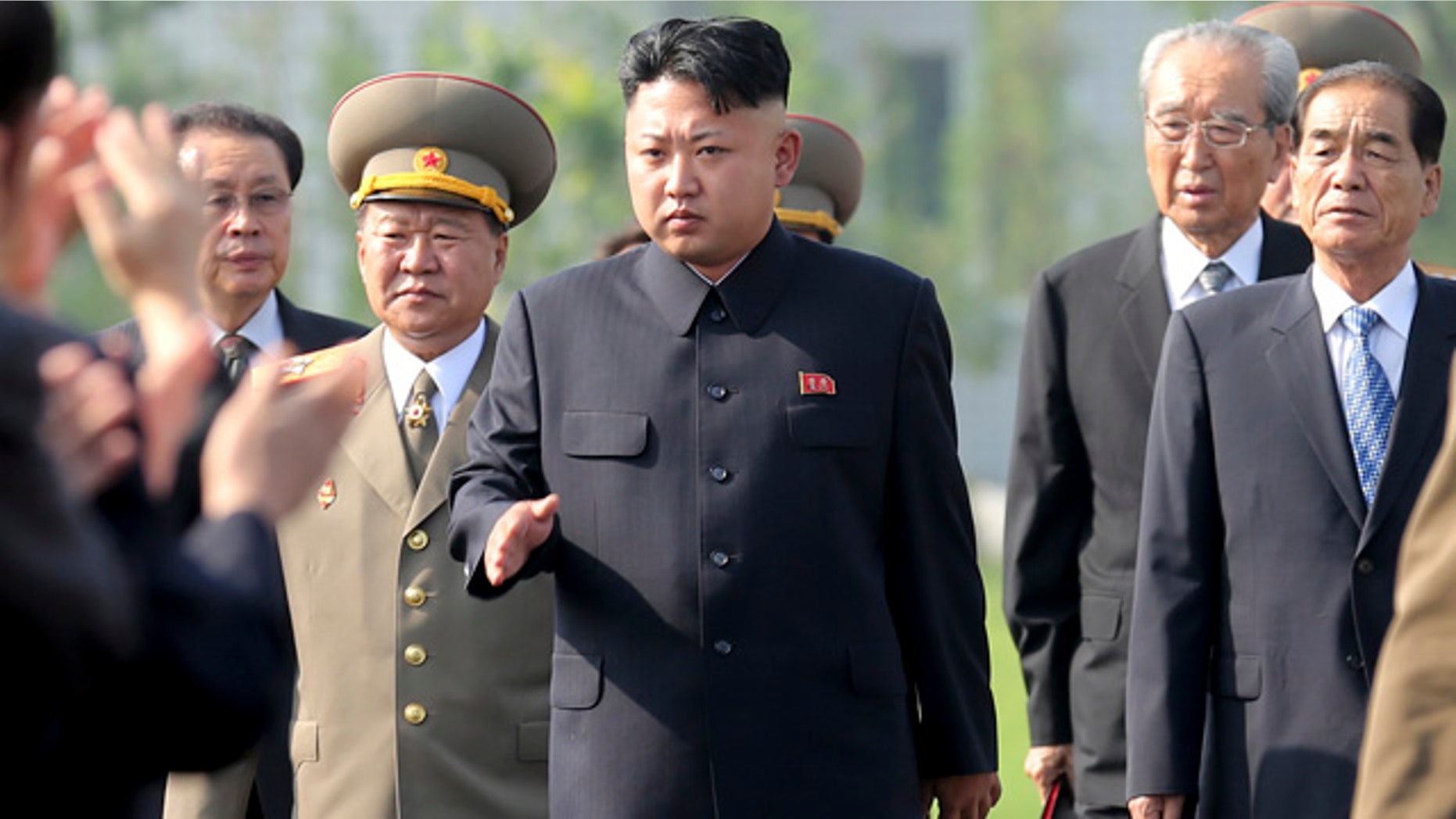 FILE - In this July 25, 2013 file photo, North Korean leader Kim Jong Un, center, arrives at the cemeteries of fallen fighters of the Korean People's Army Pyongyang. (AP Photo/Wong Maye-E, File)