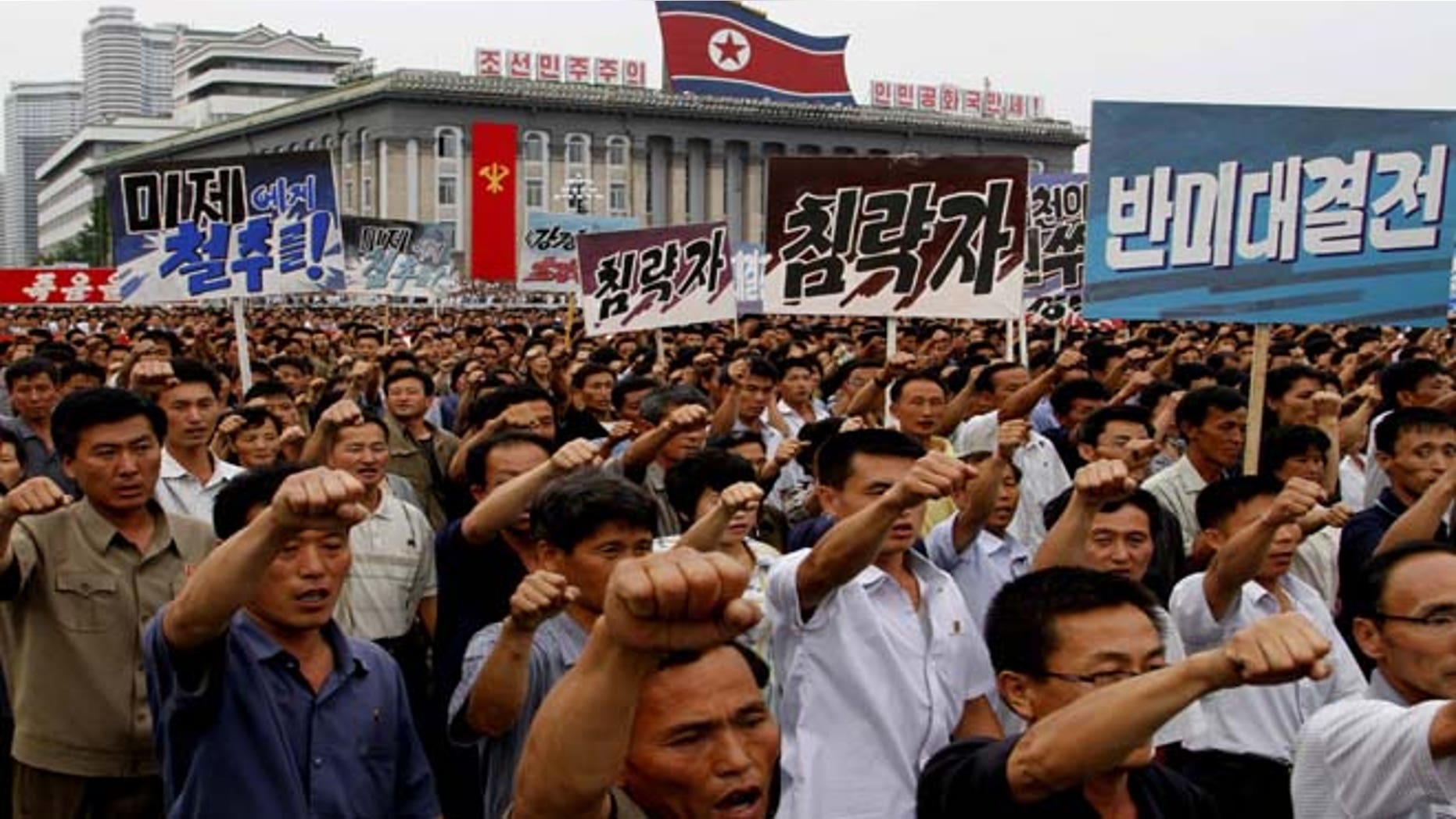 North Koreans march on Kim Il Sung Square in Pyongyang, North Korea as they hold an anti-U.S. demonstration on Tuesday, the 63rd anniversary of the outbreak of the three-year Korean War, from 1950 to 1953.
