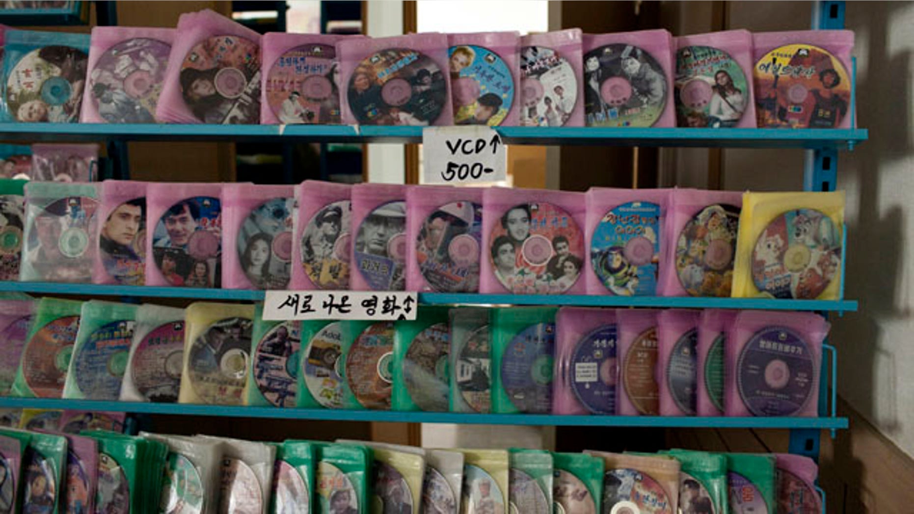FILE - In this June 20, 2013 file photo, movie DVD and VCD disks are arranged on a shelf at a store in Pyongyang, North Korea. (AP Photo/Alexander F. Yuan, File)