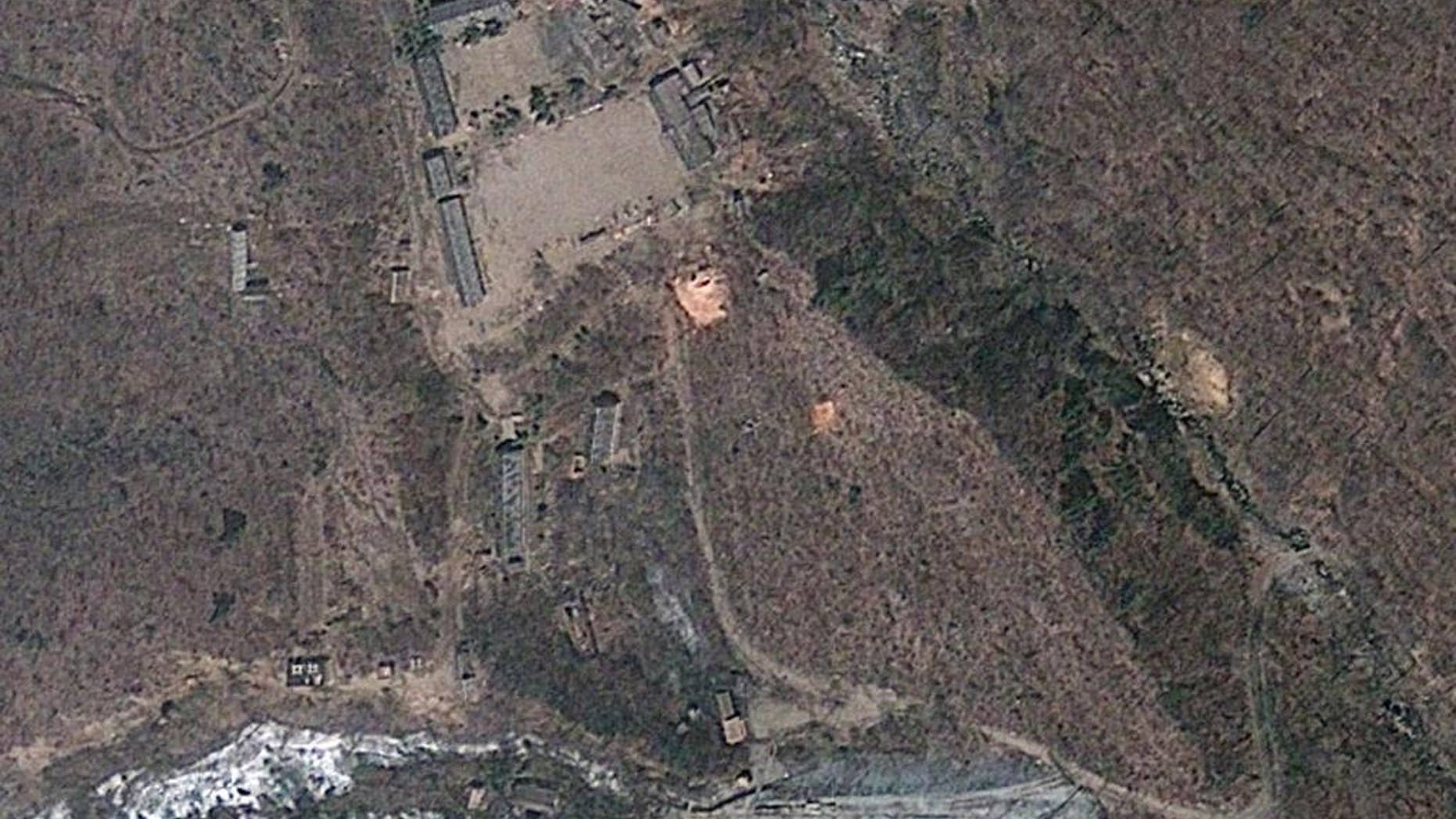 This April 18, 2012 satellite image provided by GeoEye shows North Korea's Punggye-ri nuclear test site. Commercial satellite imagery shows increased activity at North Korea’s nuclear test site but not enough to indicate an underground atomic explosion is imminent, a U.S. research institute said Tuesday. North Korea last month threatened to conduct its fourth nuclear test and there’s been speculation it may do so as President Barack Obama travels to Asia this week. (AP Photo/GeoEye)