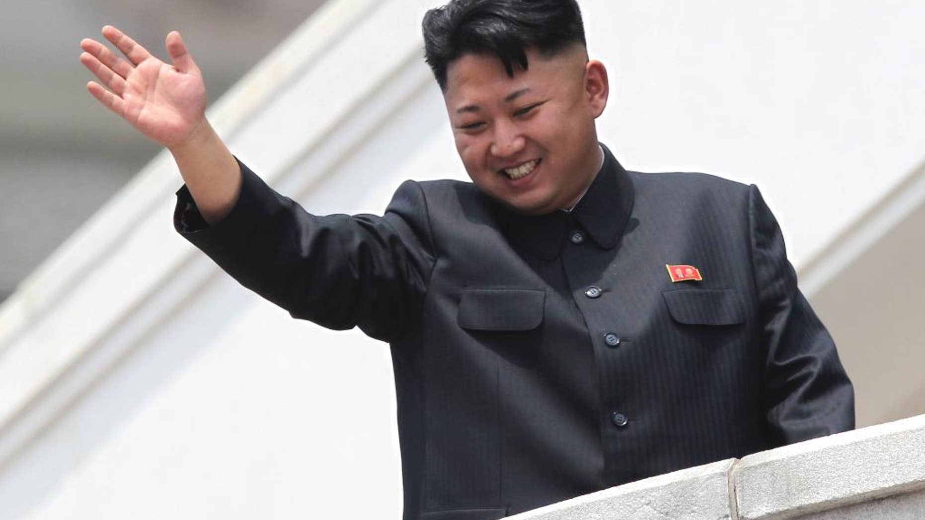 FILE - In this July 27, 2013 photo, North Korean leader Kim Jong Un waves to war veterans during a mass military parade celebrating the 60th anniversary of the Korean War armistice in Pyongyang, North Korea. From "Saturday Night Live" on Oct. 11, 2014 spoofs to the wild theories of journalists across the globe trying to parse his five-week absence from the public eye, the 30-something leader of North Korea has captured as many headlines as he did when he threatened to nuke his enemies last year. This bewildering ability to command attention by doing nothing says a lot about the North’s total mastery of a propaganda apparatus that puts Kim at the center of everything. (AP Photo/Wong Maye-E, File)