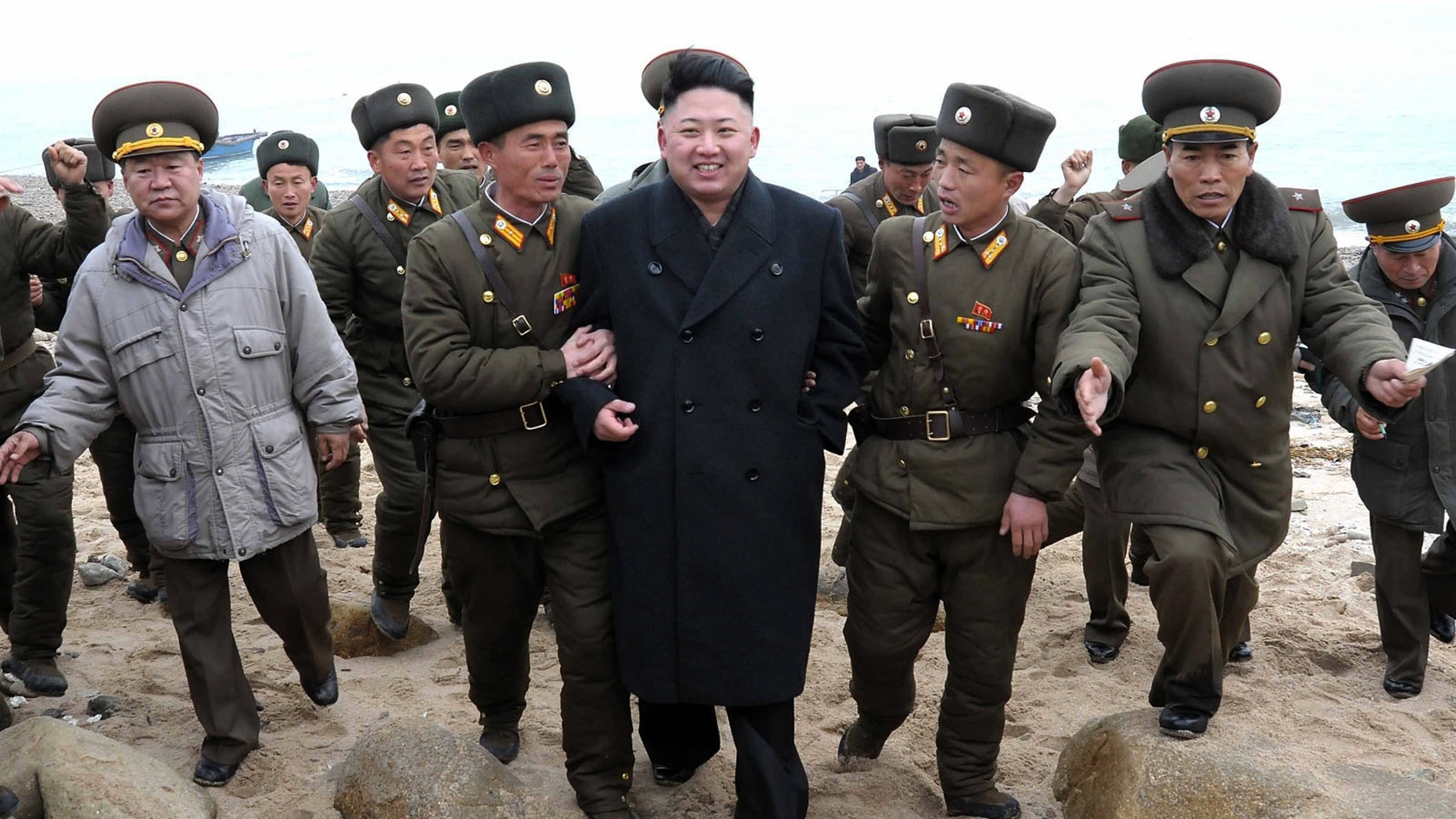 March 7, 2013 - North Korean leader Kim Jong Un walks with military personnel as he arrives for a military unit on Mu Islet, in the southernmost part of North Korea's border with South Korea.