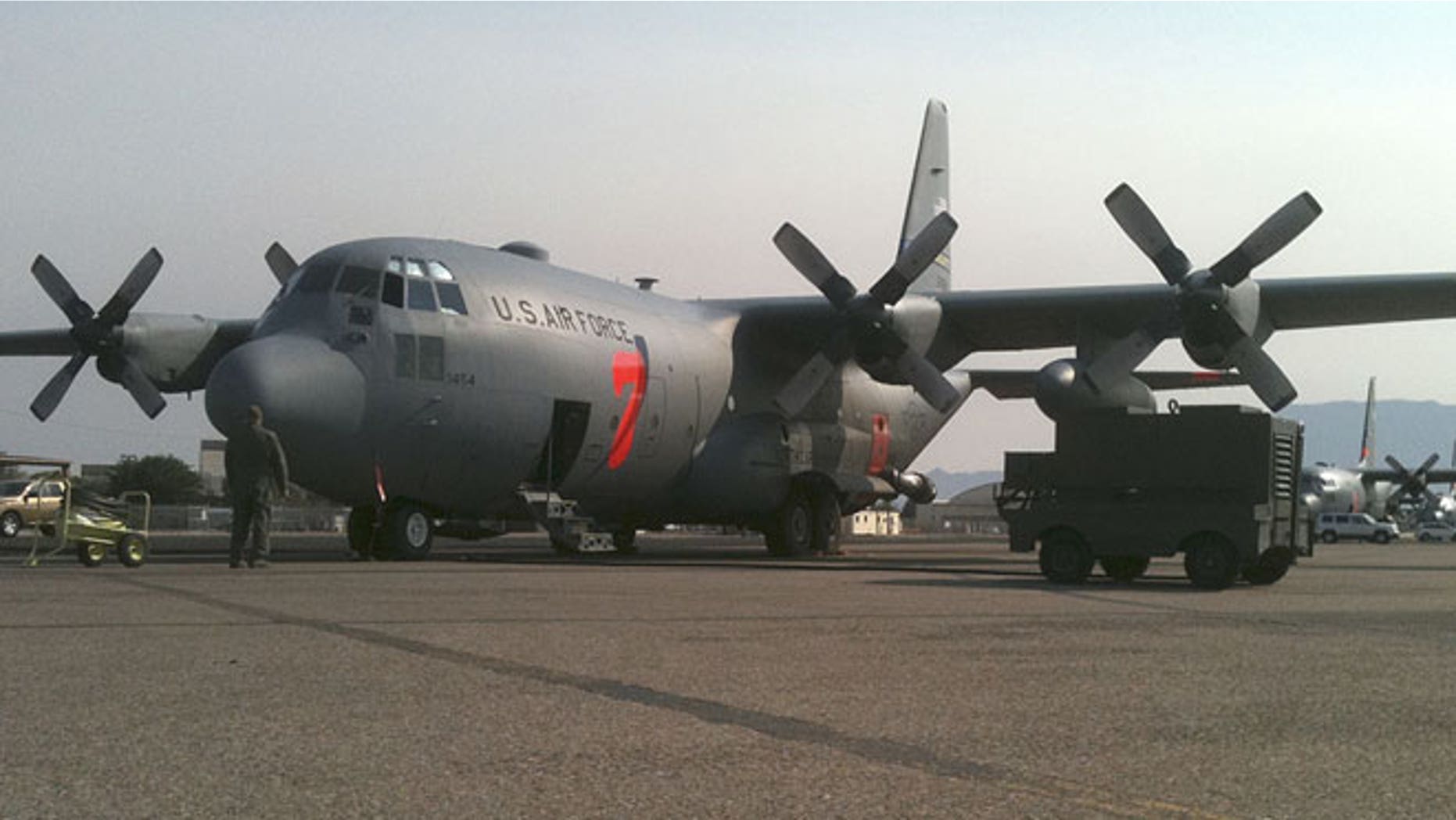 In this July 2, 2011 photo provided by the North Carolina National Guard, a crew prepares a C-130 MAFFS 7 (Modular Airborne FireFighting System) cargo plane to battle a wildfire, in Albuquerque, New Mexico.