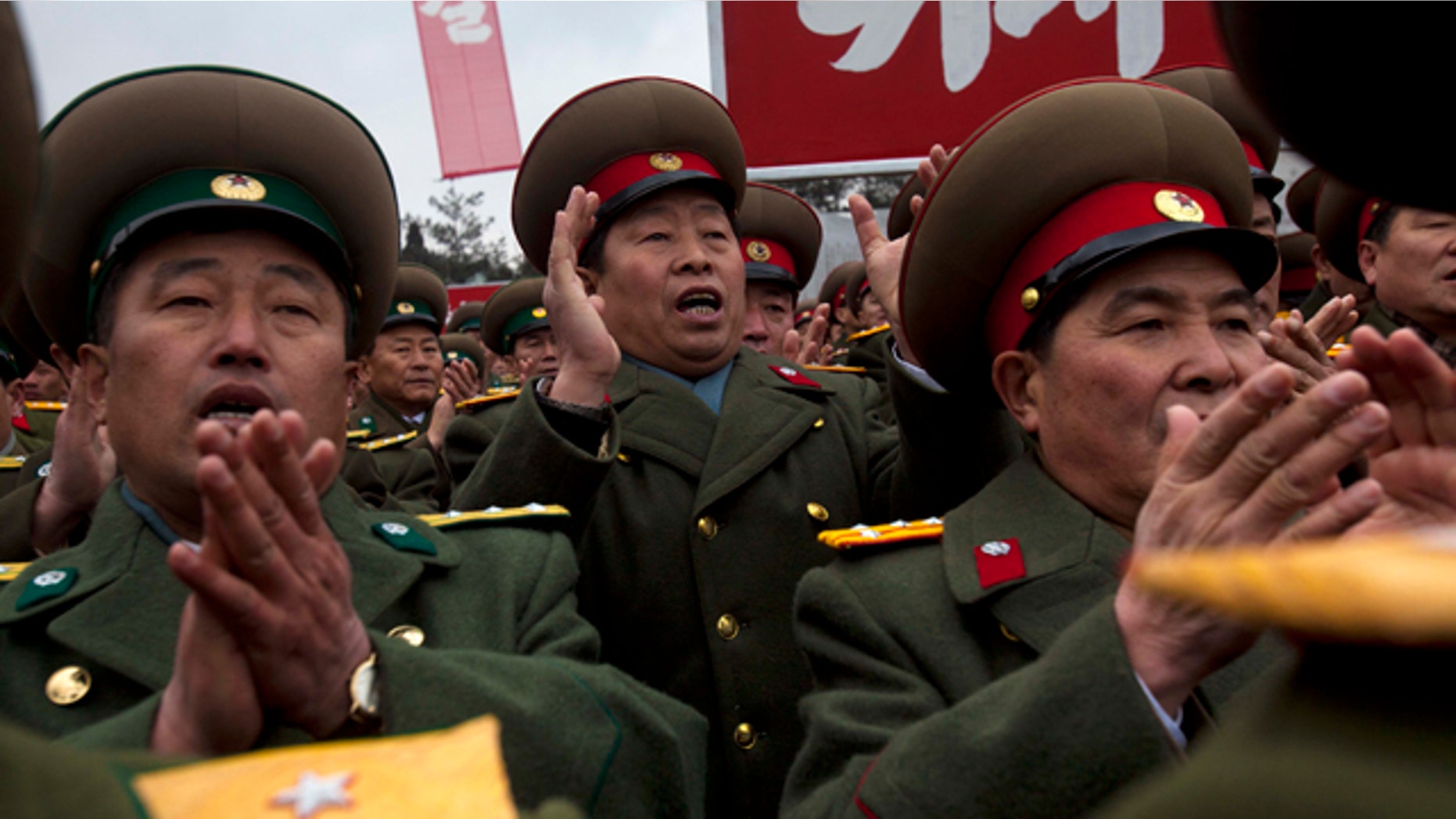 Feb.14,2012- North Korean military members cheer during the unveiling of a new bronze statue depicting the late leader Kim Jong Il and his father Kim Il Sung at Mansudae Art Studio in Pyongyang. As North Koreans prepare for what would have been the 70th birthday of late leader Kim Jong Il this week, the country's state media have gone to great lengths to build up the man who led the nation for 17 years until his death in December.
