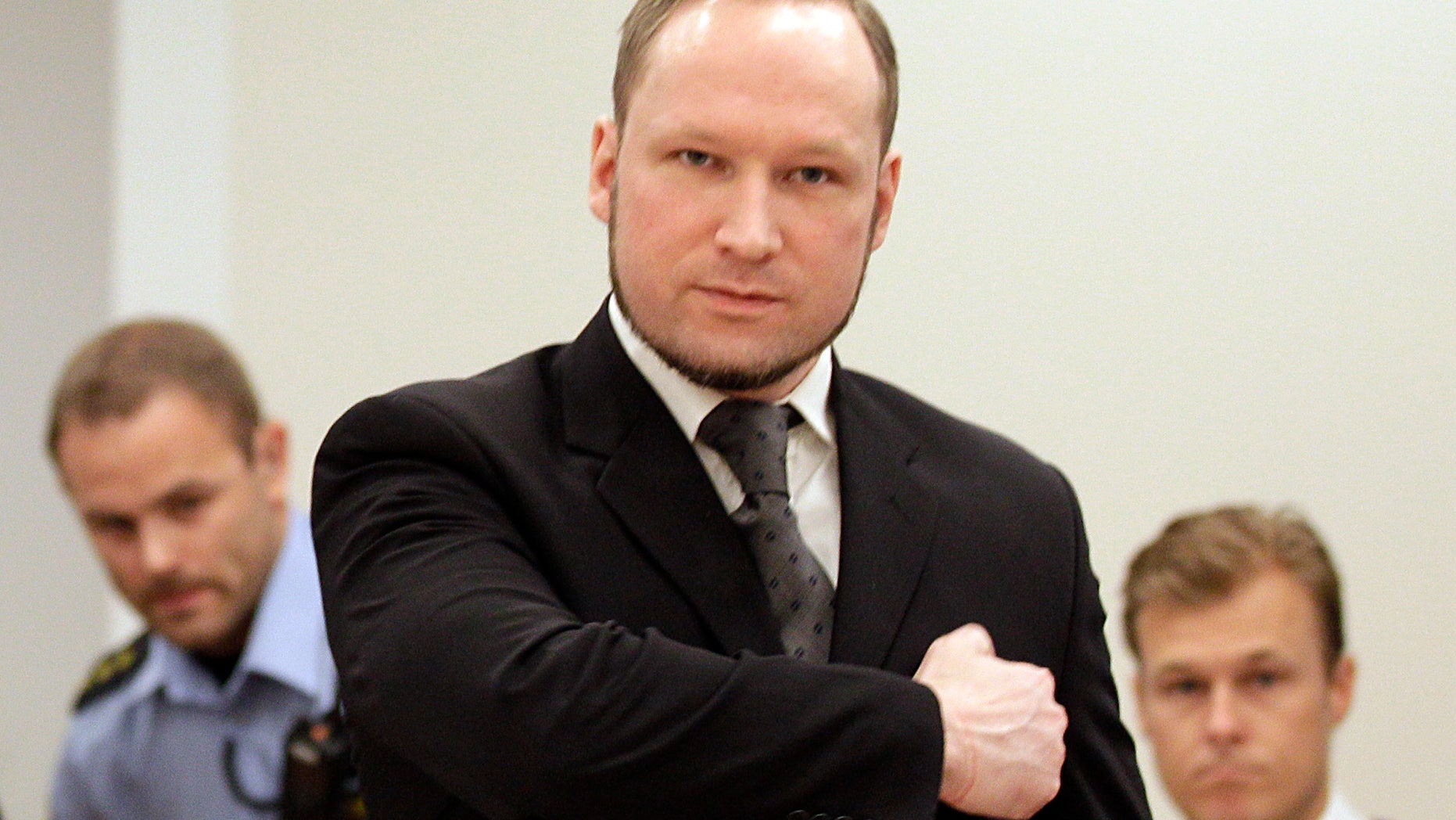 Aug. 24, 2012: Norwegian Anders Behring Breivik gestures as he arrives at the courtroom in Oslo, Norway. Anders Behring Breivik has been declared sane and sentenced to prison for bomb and gun attacks that killed 77 people last year.