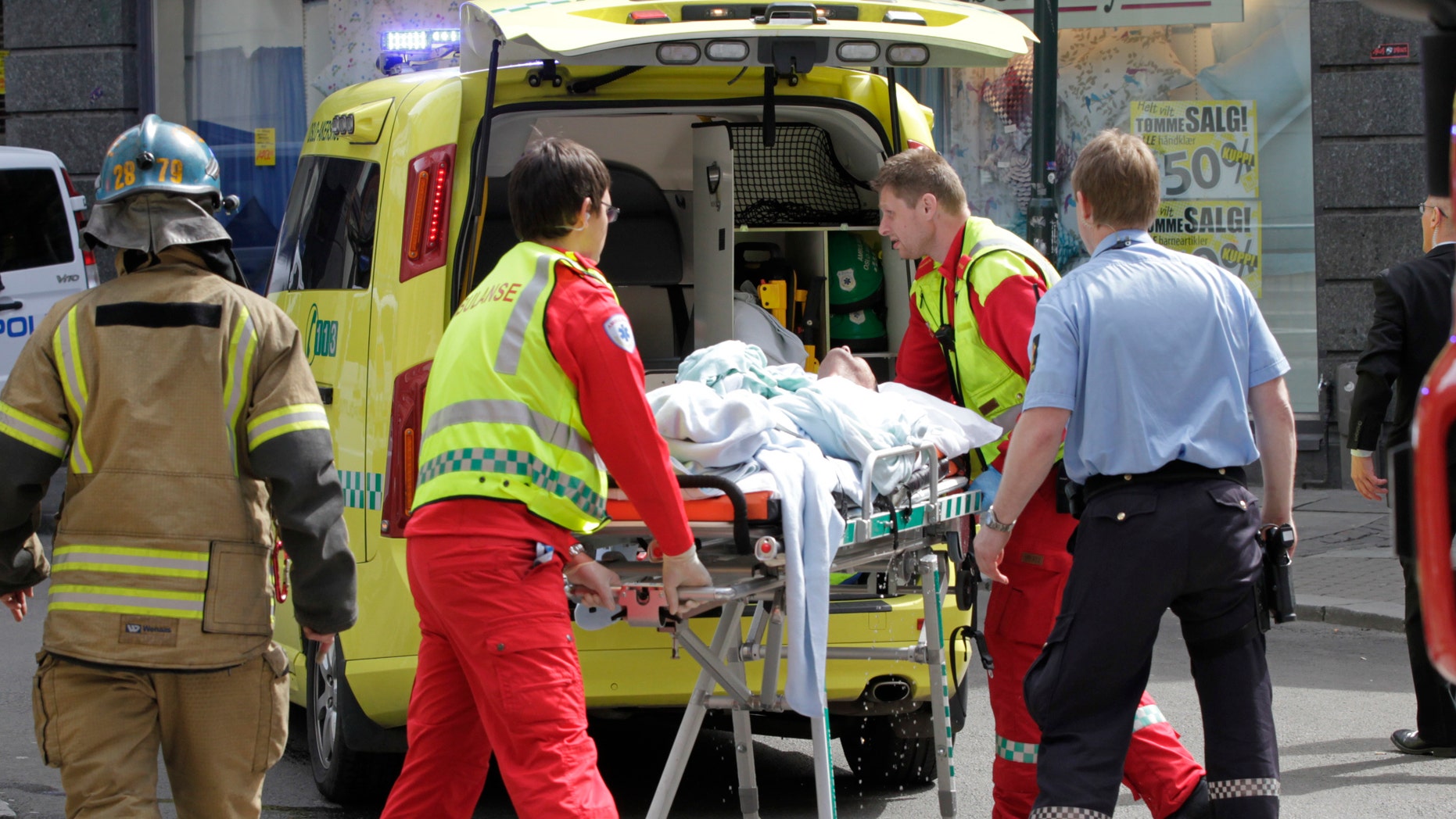 May 15, 2012: A man who set fire to himself outside the courthouse in Oslo where the trial of Anders Behring Breivik is taking place, is taken into an ambulance.