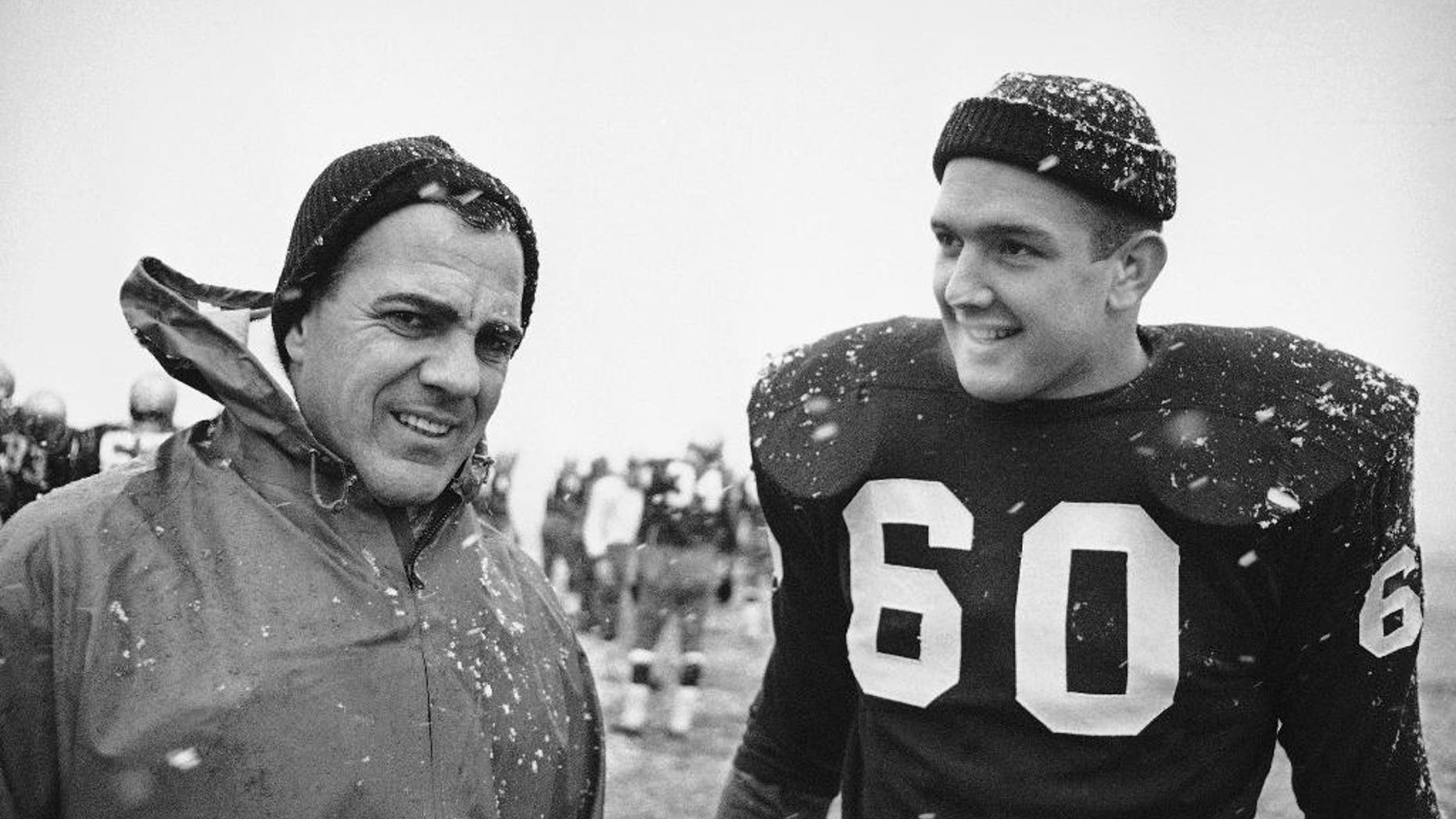 FILE - In this Nov. 20, 1964, file photo, Notre Dame coach Ara Parseghian, left, and team captain James Carroll are shown during a practice session in South Bend. Notre Dame was at rock bottom when Ara Parseghian took over 50 years ago. The Irish finished the season 2-7 in 1963 and the only thing that kept them from matching the worst record in school history set in 1956 was the game against Iowa was cancelled because of the assassination of John Kennedy. (AP Photo/Charles Knoblock, File)