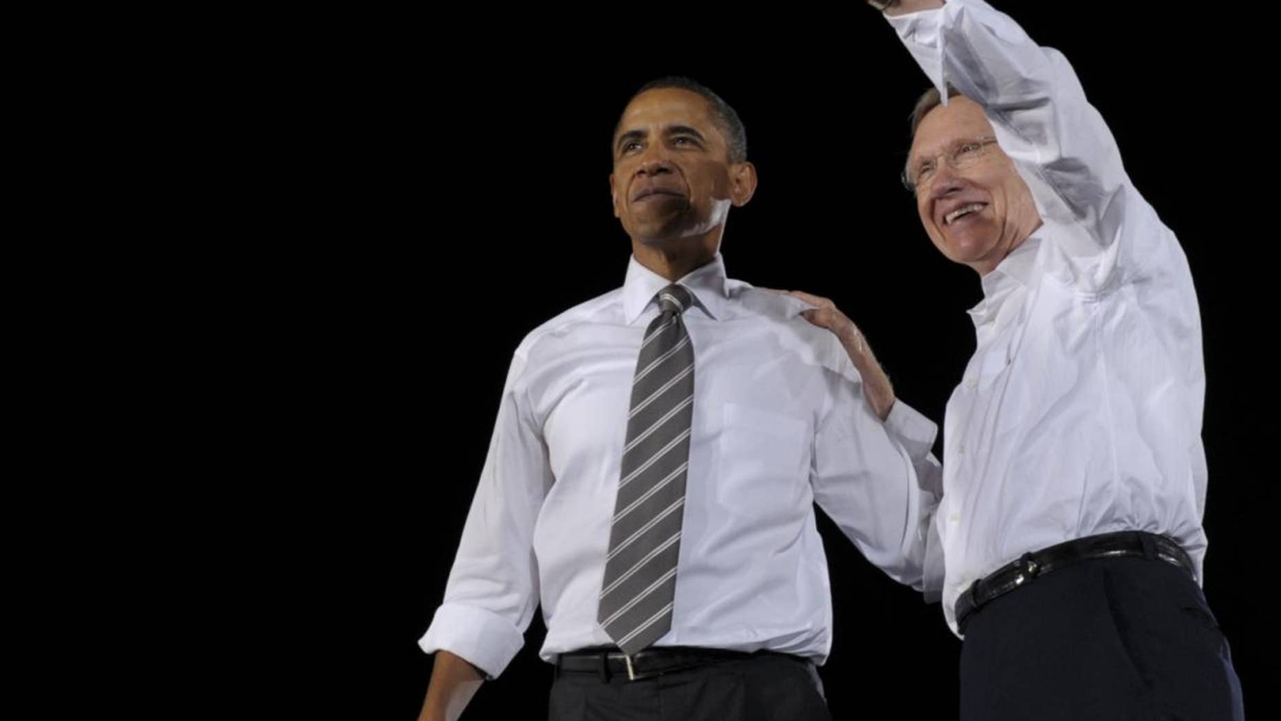 President Obama campaigning with Harry Reid. (AP Photo)
