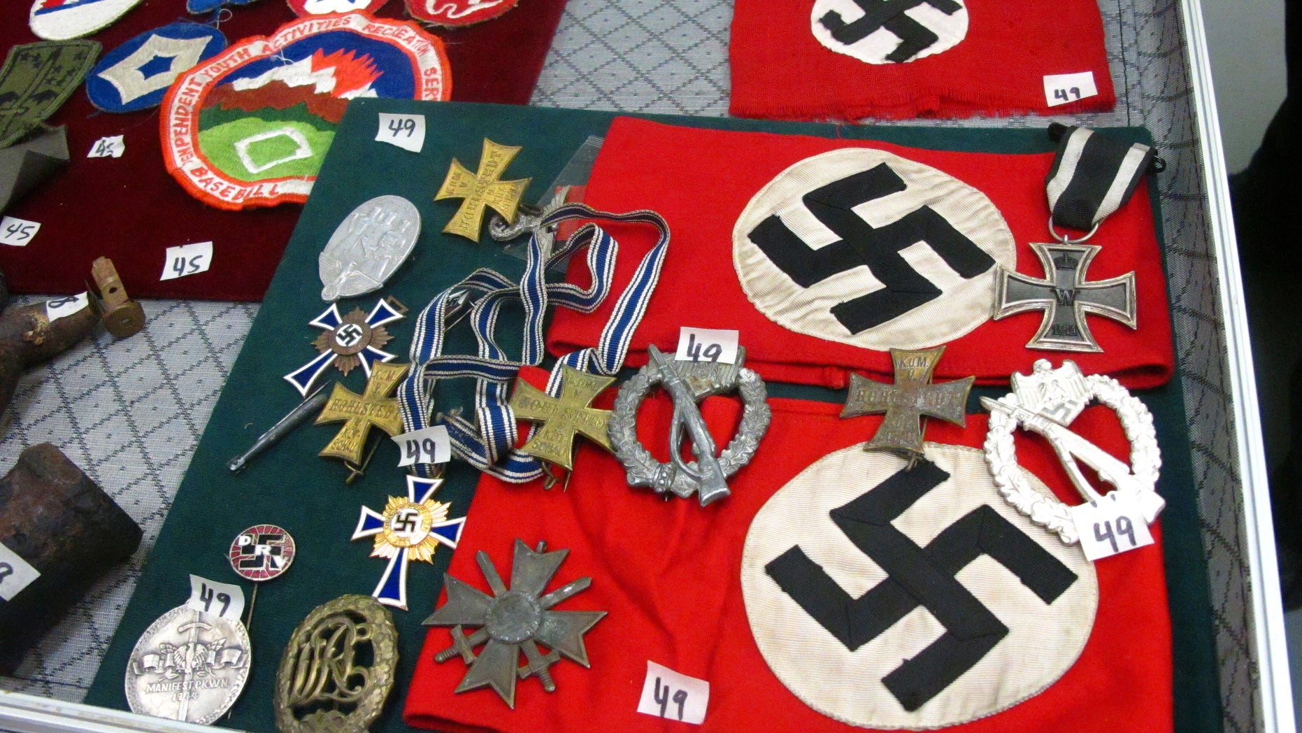 Sept. 19, 2014: This photo shows medals and Nazi armbands at an auction house in Anchorage, Alaska. Those items are among World War II items, including carbon copies of Nuremberg trial transcripts, that are being auctioned off Saturday through the Alaska Auction Co. (AP/Rachel D'Oro)