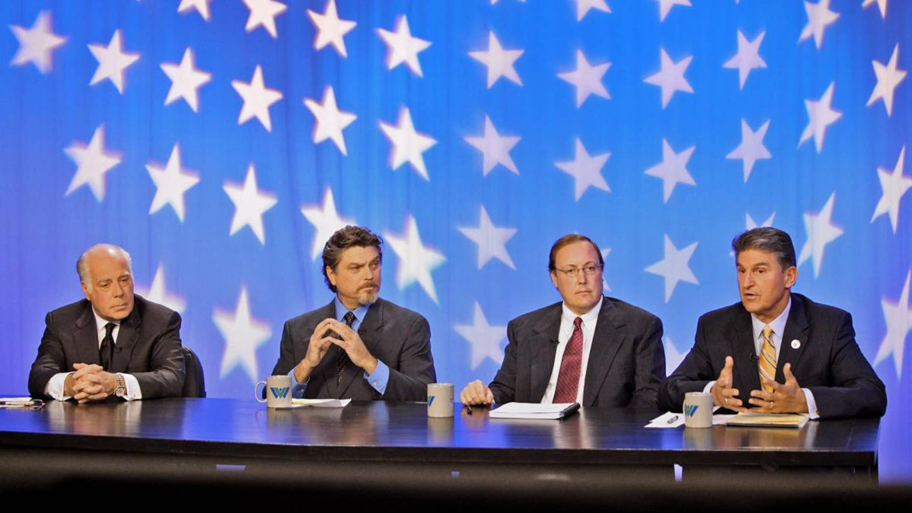 West Virginia senatorial candidates Republican John Raese, Mountain Party candidate Jesse Johnson, and Constitutional Party candidate Jeff Becker, in Morgantown, W.Va. on Monday, Oct. 18, 2010/AP Photo