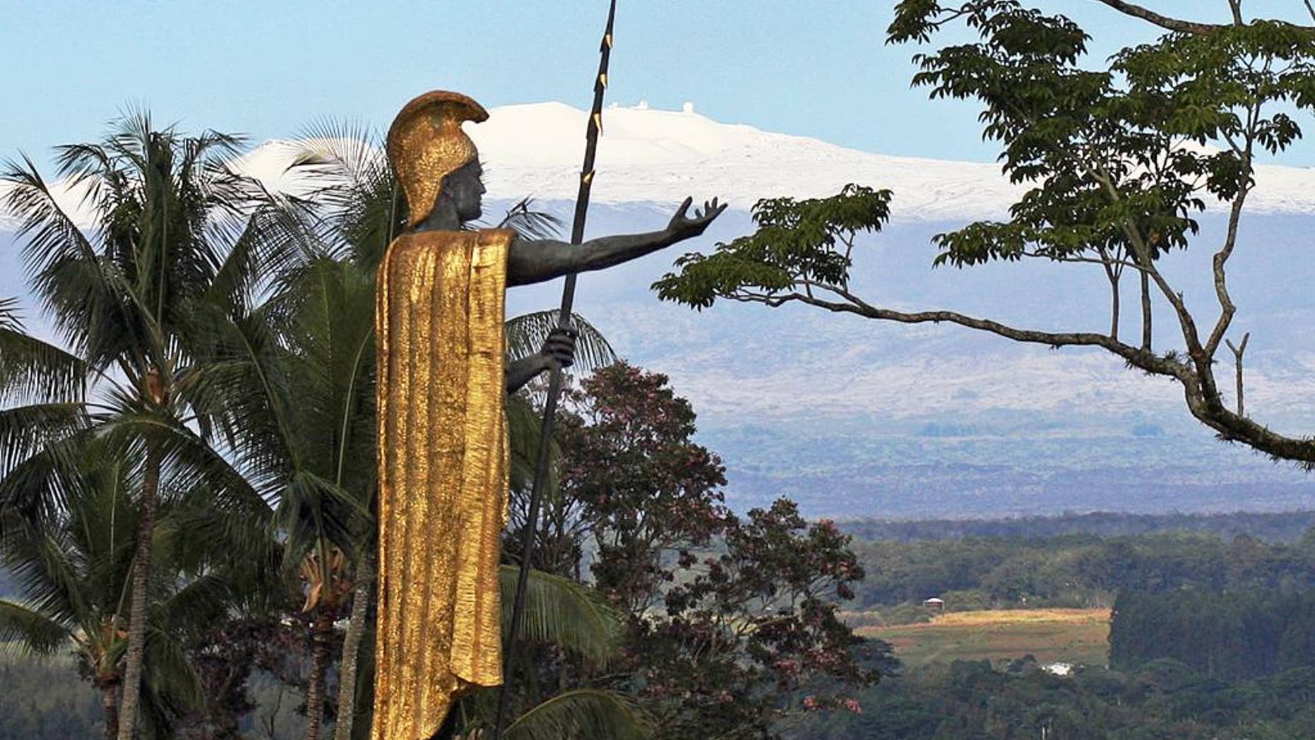 FILE - This Jan. 31, 2014, file photo, shows a statue of Hawaiian King Kamehameha I with snow-capped Mauna Kea in the distance, in Hilo, Hawaii. Part of Kamehameha's spear is missing. Police on Hawaii's Big Island are asking the public for help locating the top section of the spear, about 6 feet long, that's part of the statue of the Hawaiian warrior. Police say the spear was last seen Saturday, Sept. 5, 2015, and was reported missing Sunday. (AP Photo/Tim Wright, File)