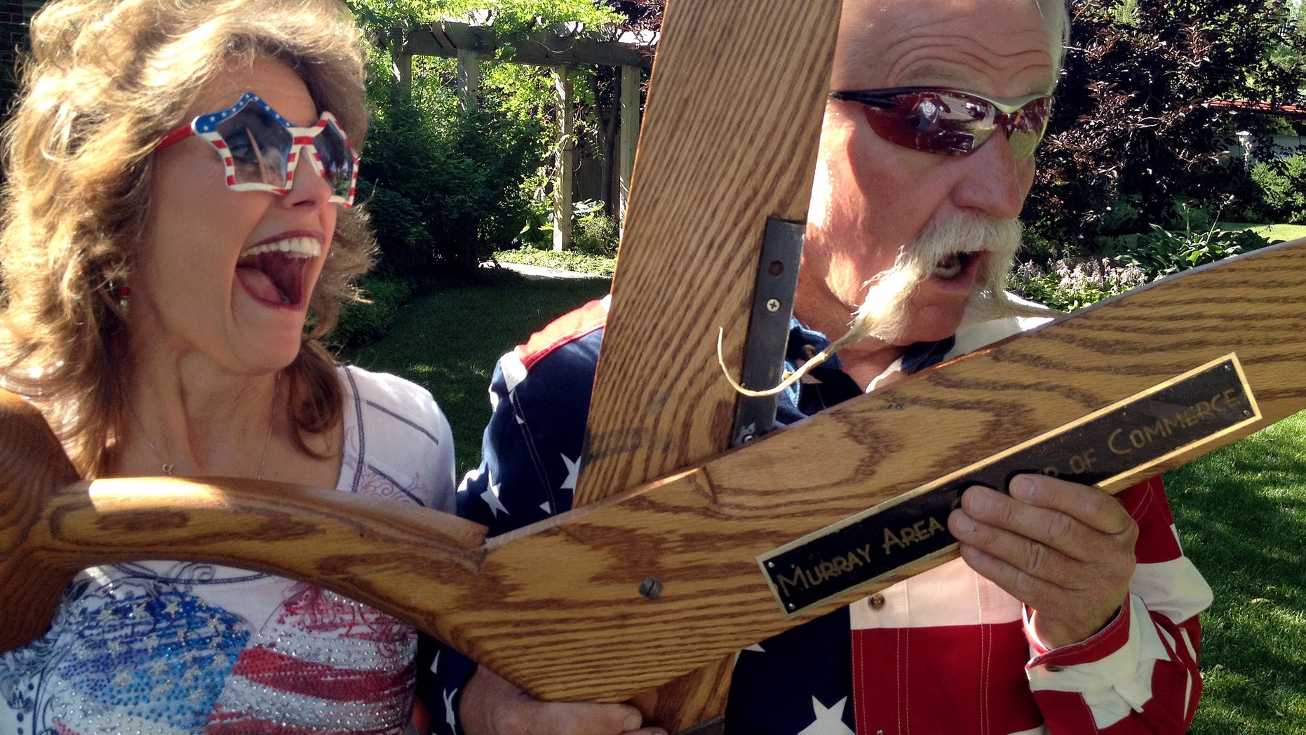 July 4, 2012: Dan Snarr, the mayor of the Salt Lake City suburb of Murray, jokes with wife, April, in Murray, Utah, after a parade in which he put all 18 inches of his handlebar mustache up for a vote. He has been growing it for 31 months but says he will shave if a majority of residents voted thumbs-down during the annual parade.