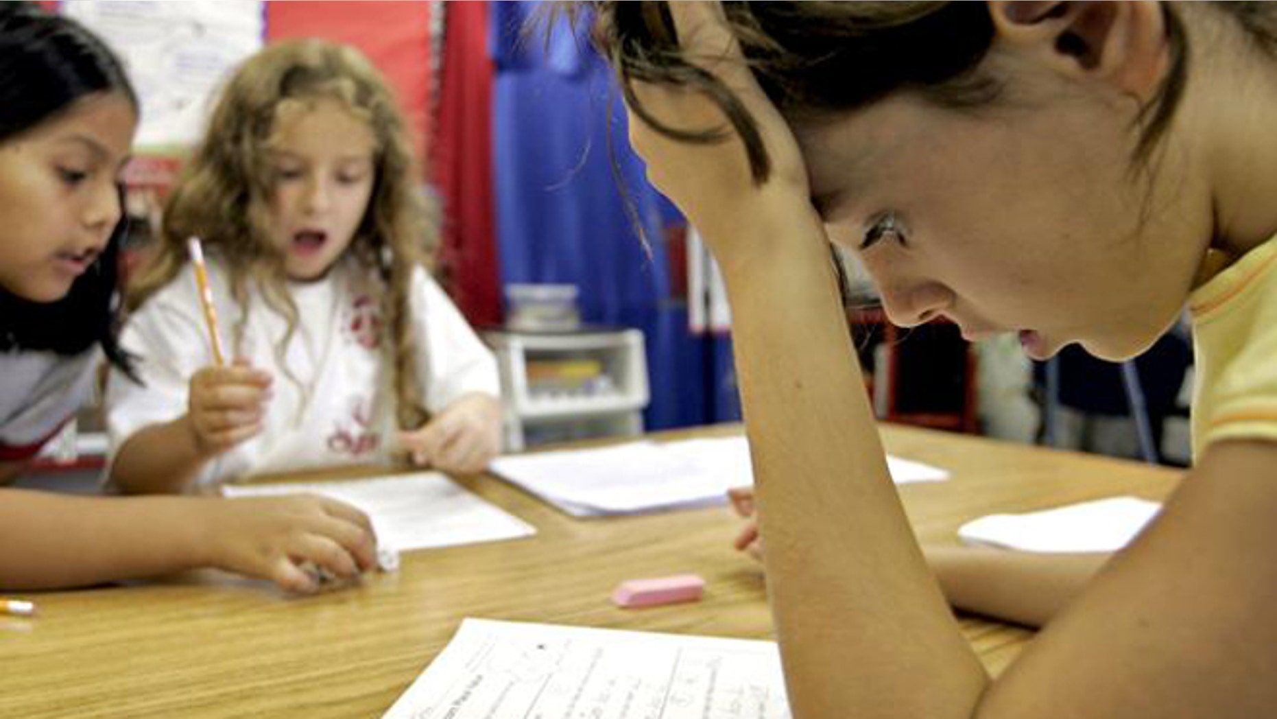 Third-grade student Georgia Allin, right, participates in a math exercise with classmates.