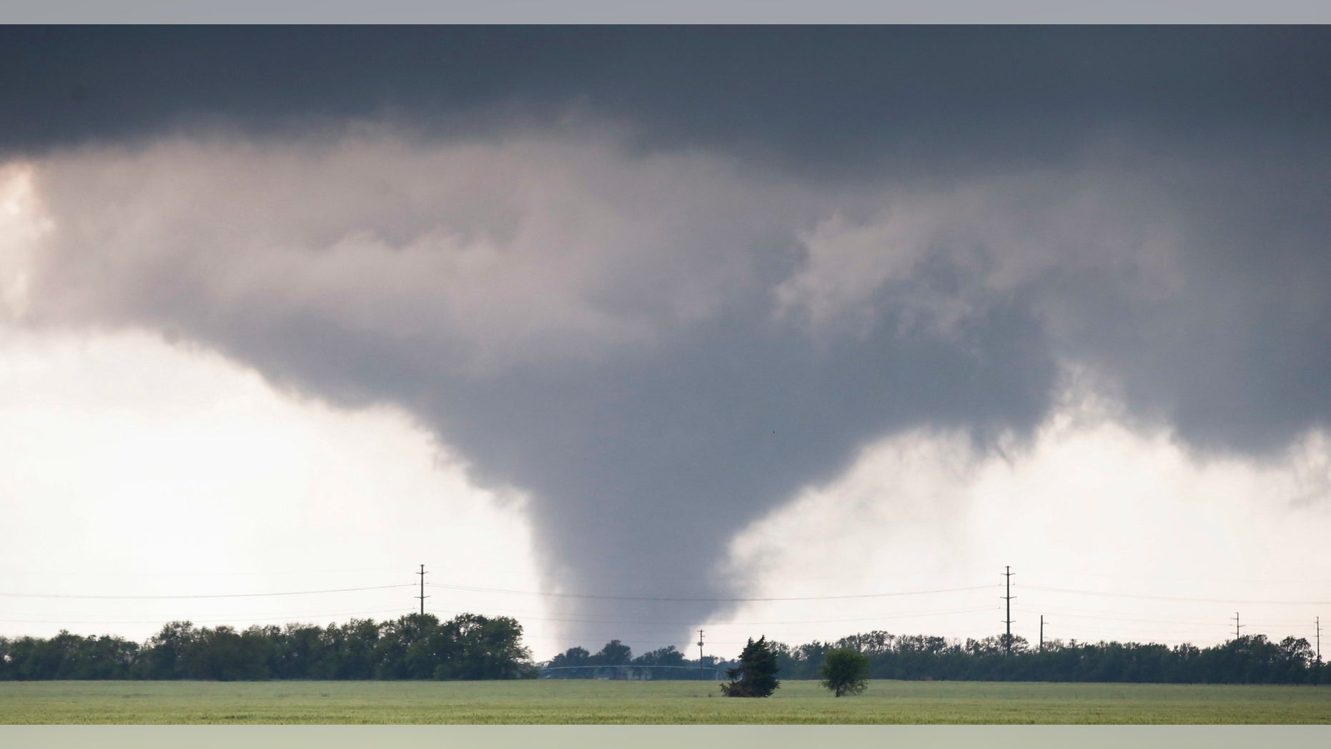 A large tornado passes just to the west of the city of Halstead, Kan., Wednesday, May 6, 2015. A swath of the Great Plains is under a tornado watch Wednesday, including parts of North Texas, Oklahoma, Kansas and Nebraska. (Travis Heying/The Wichita Eagle via AP) LOCAL TELEVISION OUT; MAGS OUT; LOCAL RADIO OUT; LOCAL INTERNET OUT