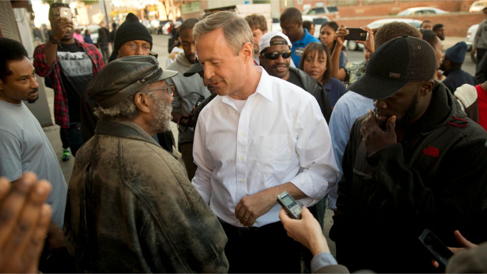 April 28, 2015: Former Maryland Gov. Martin O'Malley, center, meets with residents in Baltimore, Md.