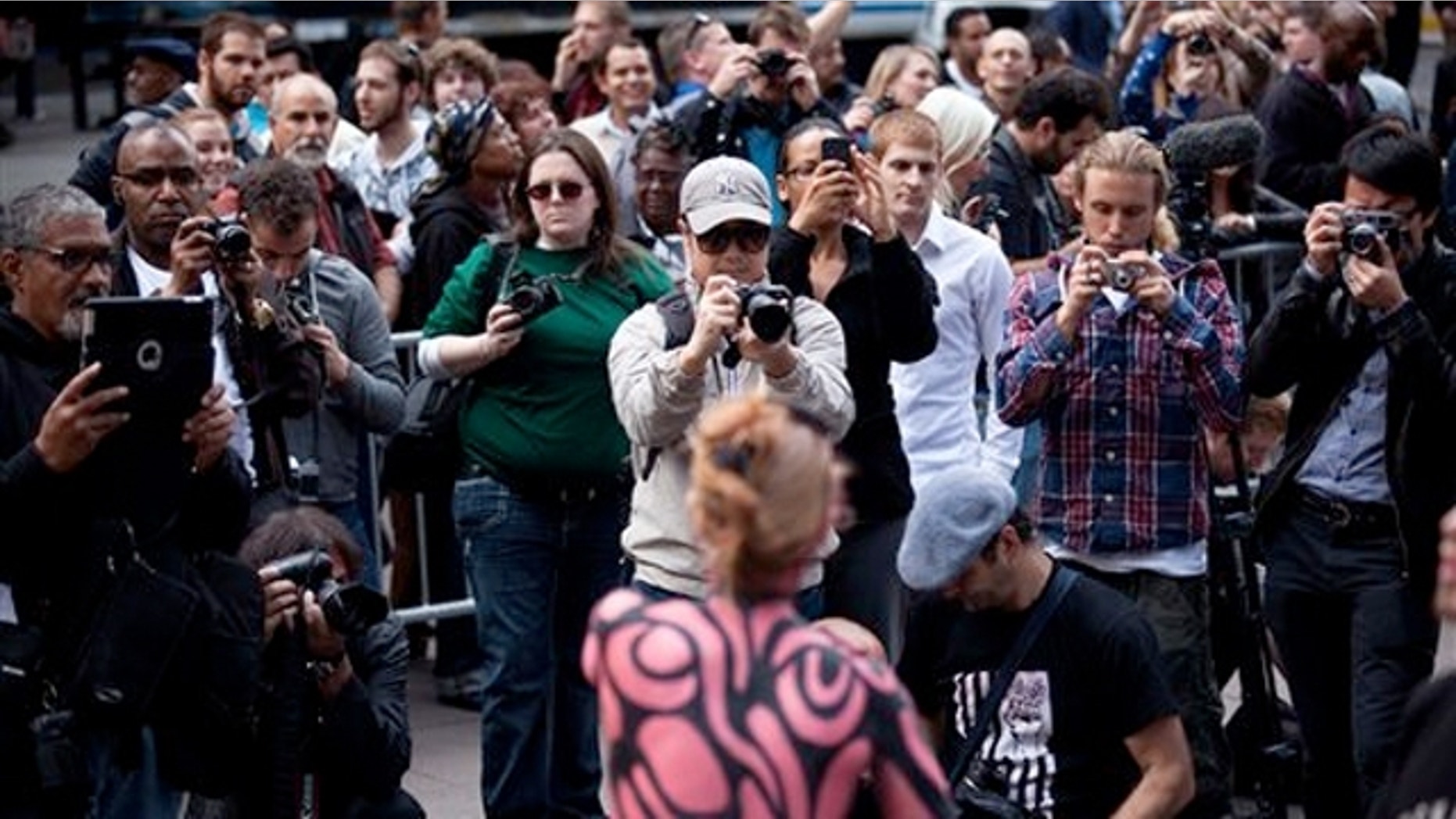 Oct. 18, 2011: Spectators swarm the Occupy Wall Street protests with their cameras in Zuccotti Park in New York.