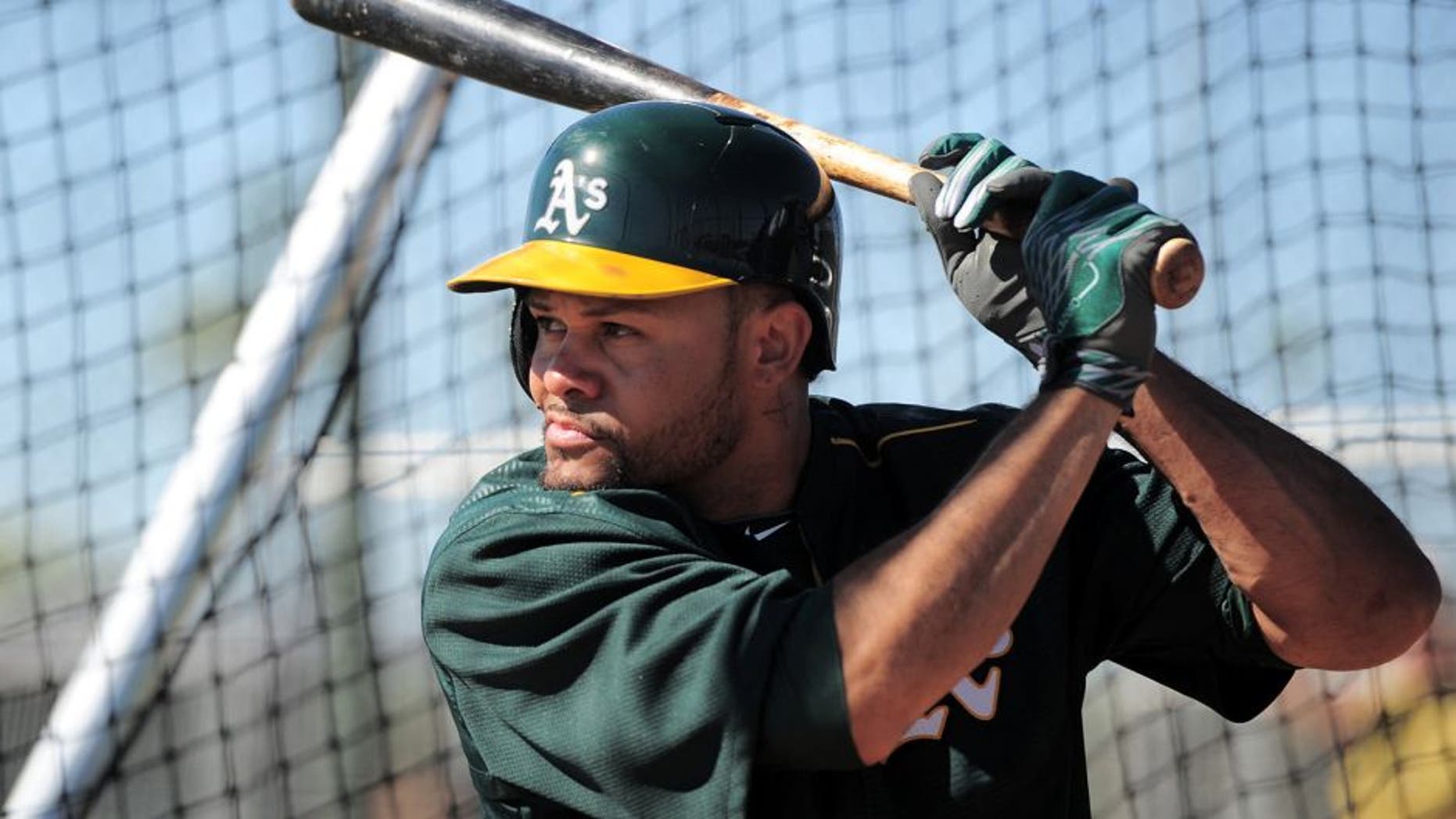 Feb 25, 2015; Mesa, AZ, USA; Oakland Athletics center fielder Coco Crisp (4) bats during a workout at Fitch Park. Mandatory Credit: Joe Camporeale-USA TODAY Sports