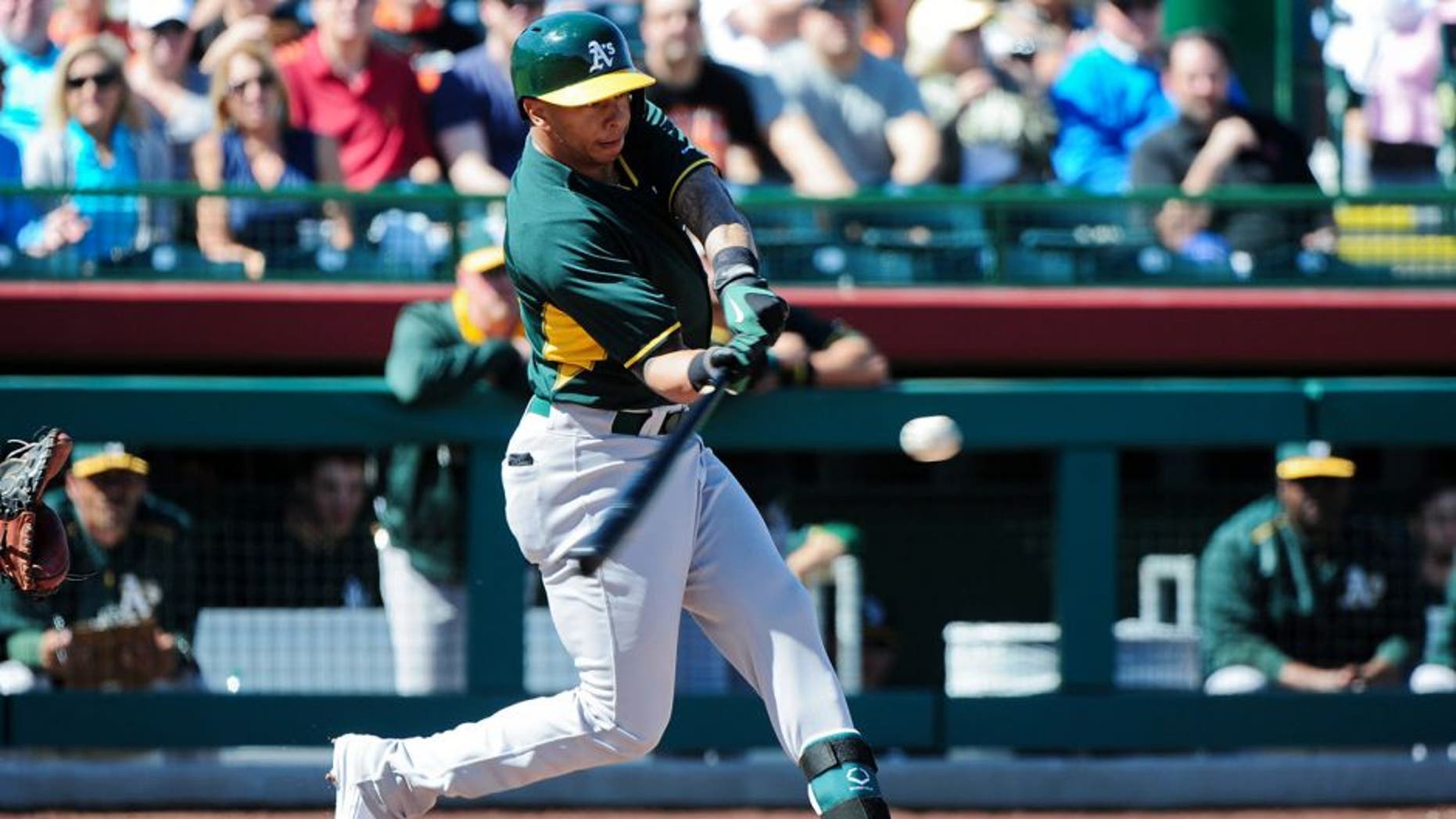 Mar 4, 2015; Scottsdale, AZ, USA; Oakland Athletics second baseman Tyler Ladendorf (25) flies out during the first inning against the San Francisco Giants during a spring training baseball game at Scottsdale Stadium. Mandatory Credit: Matt Kartozian-USA TODAY Sports