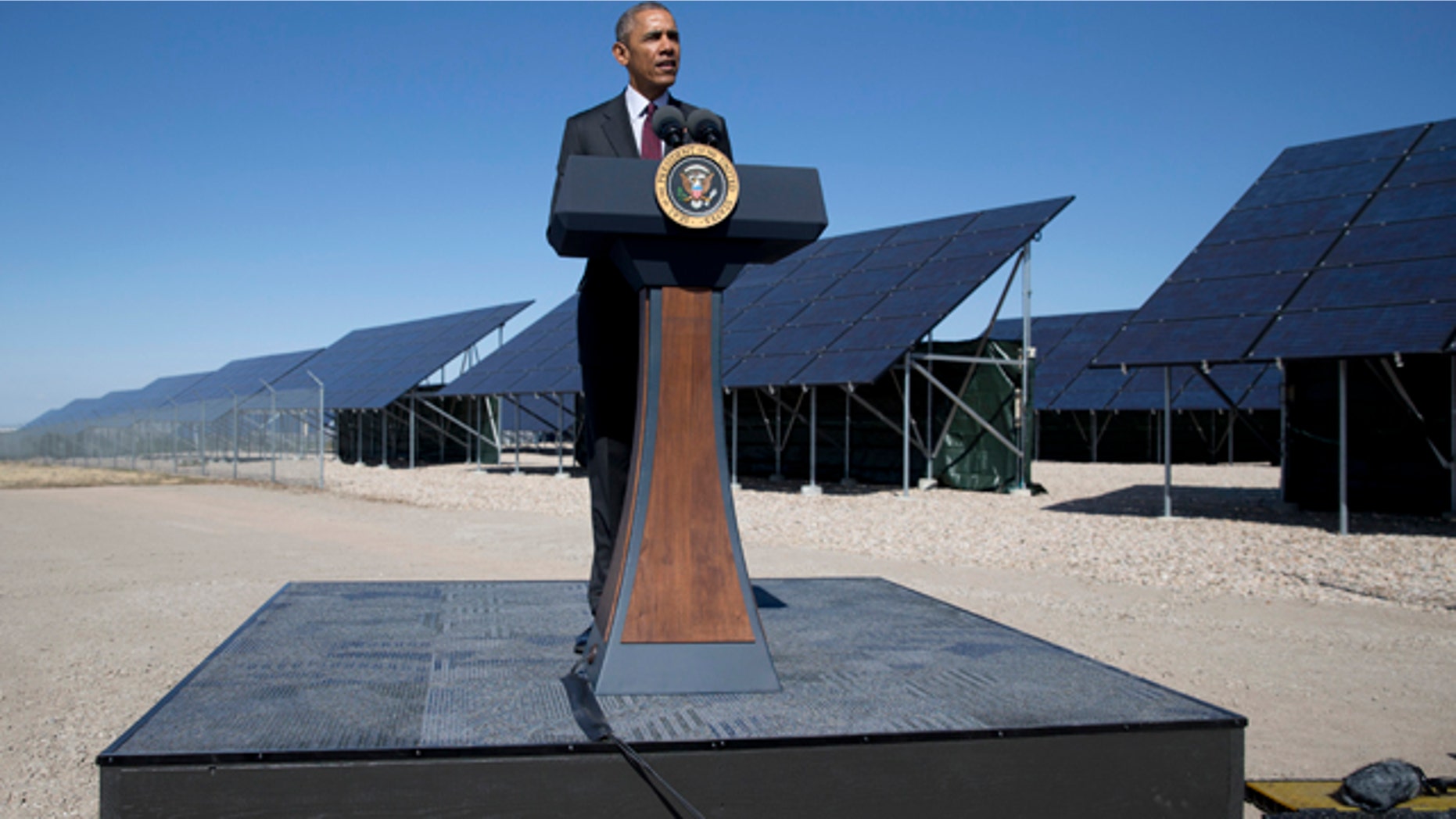 FILE - In this April 3, 2015, file photo, President Barack Obama speaks in front of a solar array at Hill Air Force Base, Utah. Obama will complete a rare presidential run though all 50 states when he delivers the commencement address at a South Dakota community college in May. (AP Photo/Carolyn Kaster, File)
