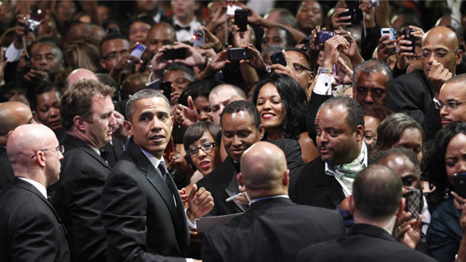 September 24: President Barack Obama turns around looking for first lady Michelle Obama as he greets the crowd at the Congressional Black Caucus Foundation Annual Phoenix Awards in Washington.
