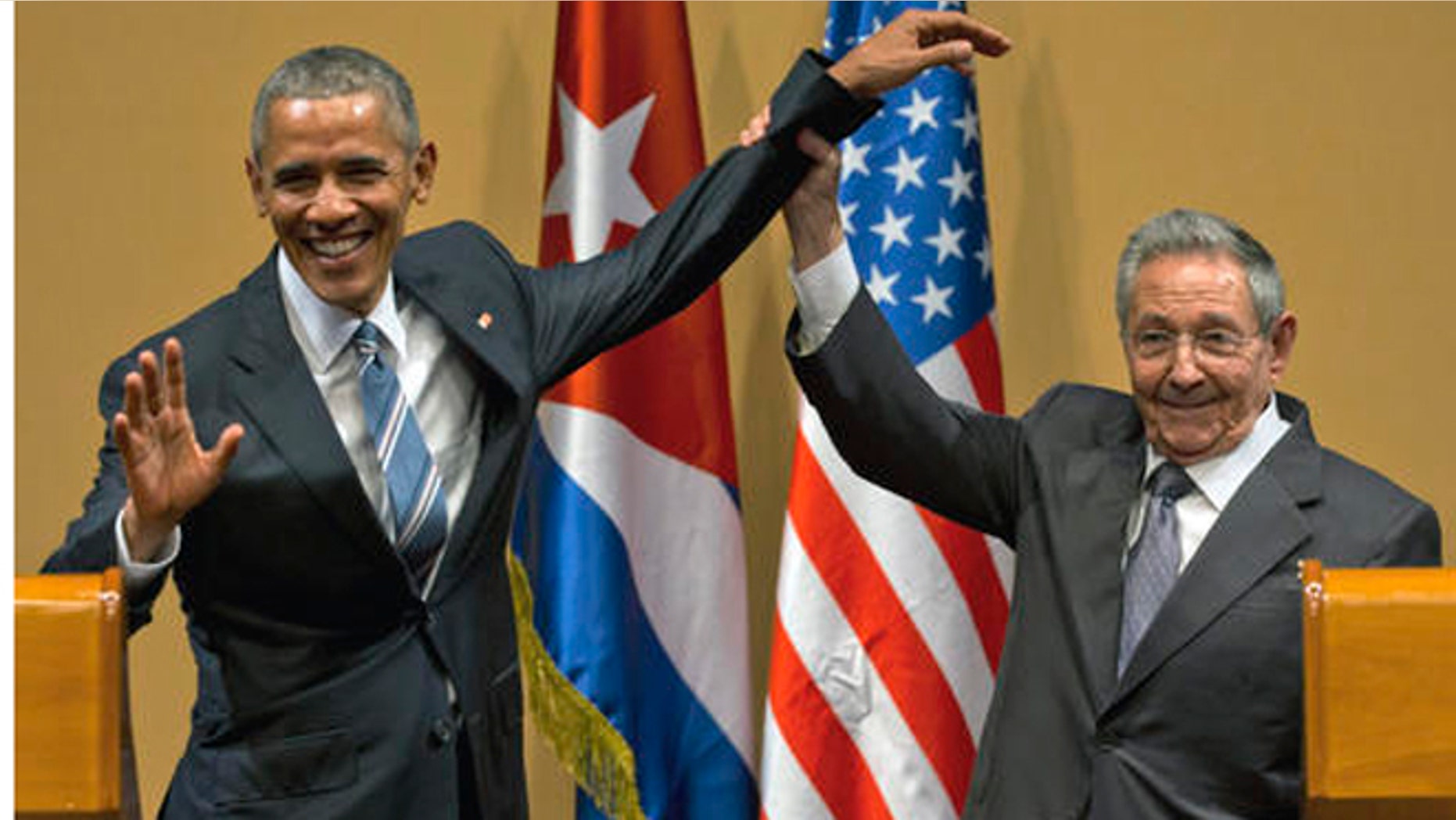 FILE - In this March 21, 2016 file photo, Cuban President Raul Castro, right, lifts up the arm of President Barack Obama at the conclusion of their joint news conference at the Palace of the Revolution, in Havana, Cuba. Donald Trumps pledge to undo Obamas detente with Cuba is provoking widespread anxiety among ordinary Cubans, who were paying little attention to the U.S. presidential campaign until now. (AP Photo/Ramon Espinosa, File)