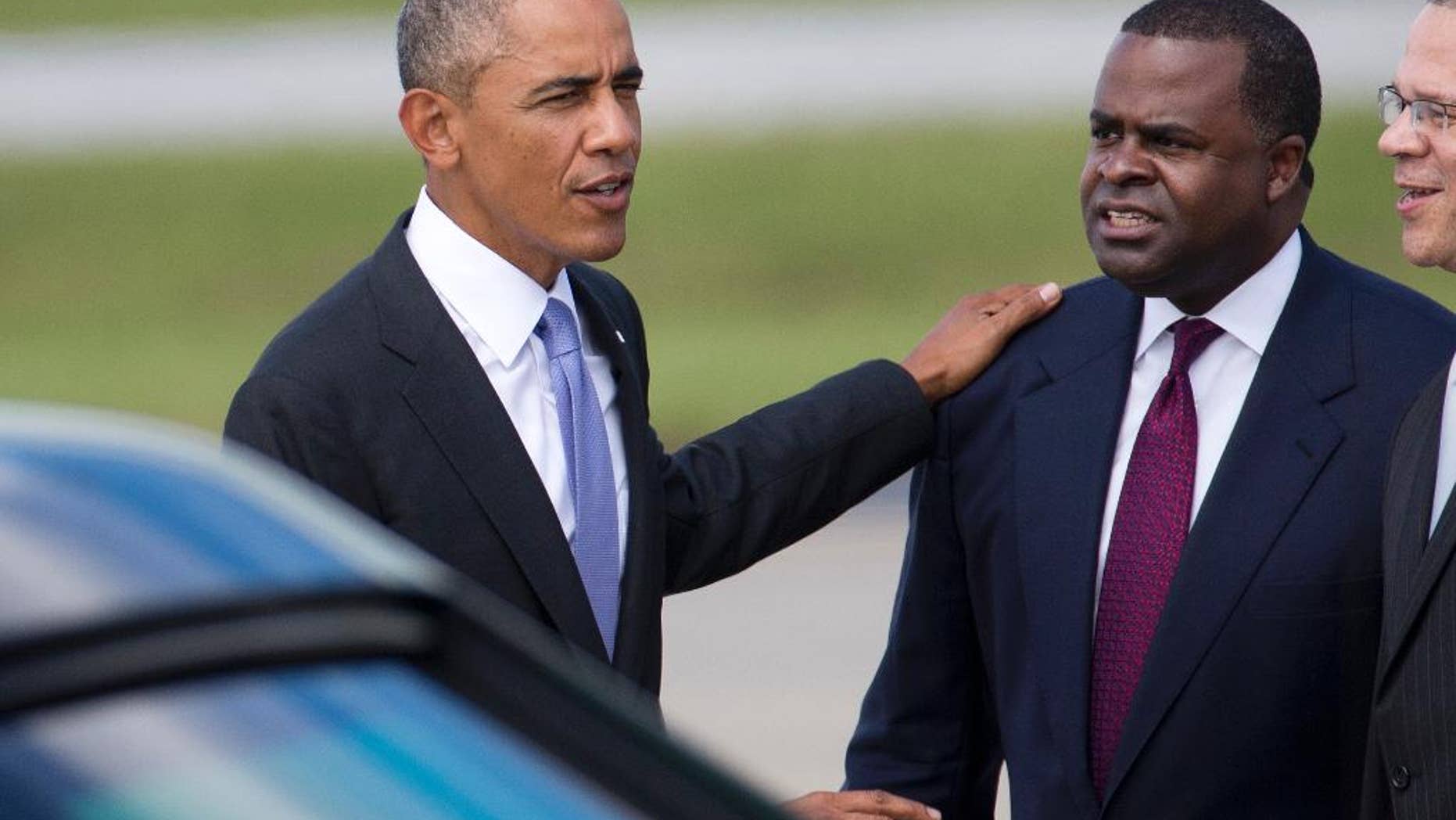 President Barack Obama chats with Atlanta Mayor Kasim Reed after arriving at Hartsfield Jackson Atlanta International Airport in Atlanta for a scheduled visit to the Centers for Disease Control and Prevention for a briefing on West Africa's Ebola out break, Tuesday, Sept. 16, 2014. (AP Photo/John Bazemore)