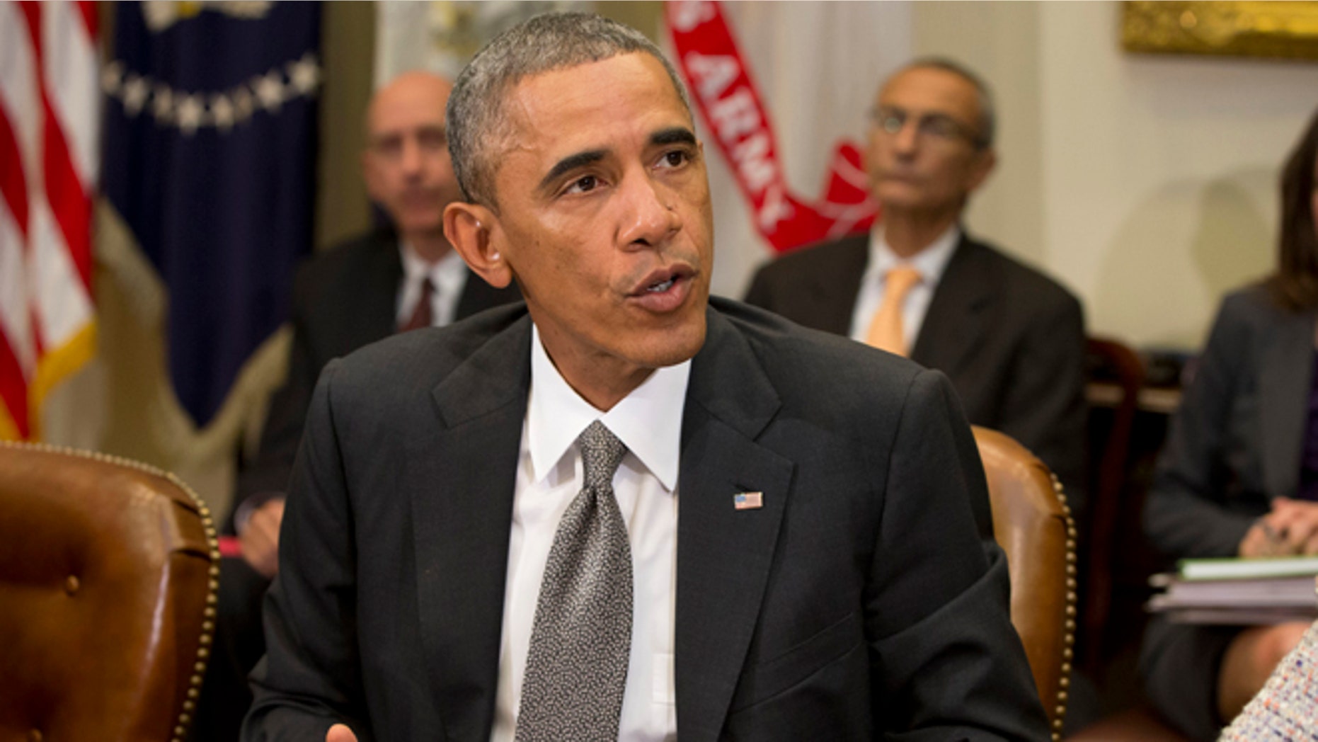 In this Monday, Oct. 6, 2014 photo, President Barack Obama meets with members of his national security team and senior staff to receive an update on the Ebola outbreak in West Africa in the Roosevelt Room of the White House in Washington.