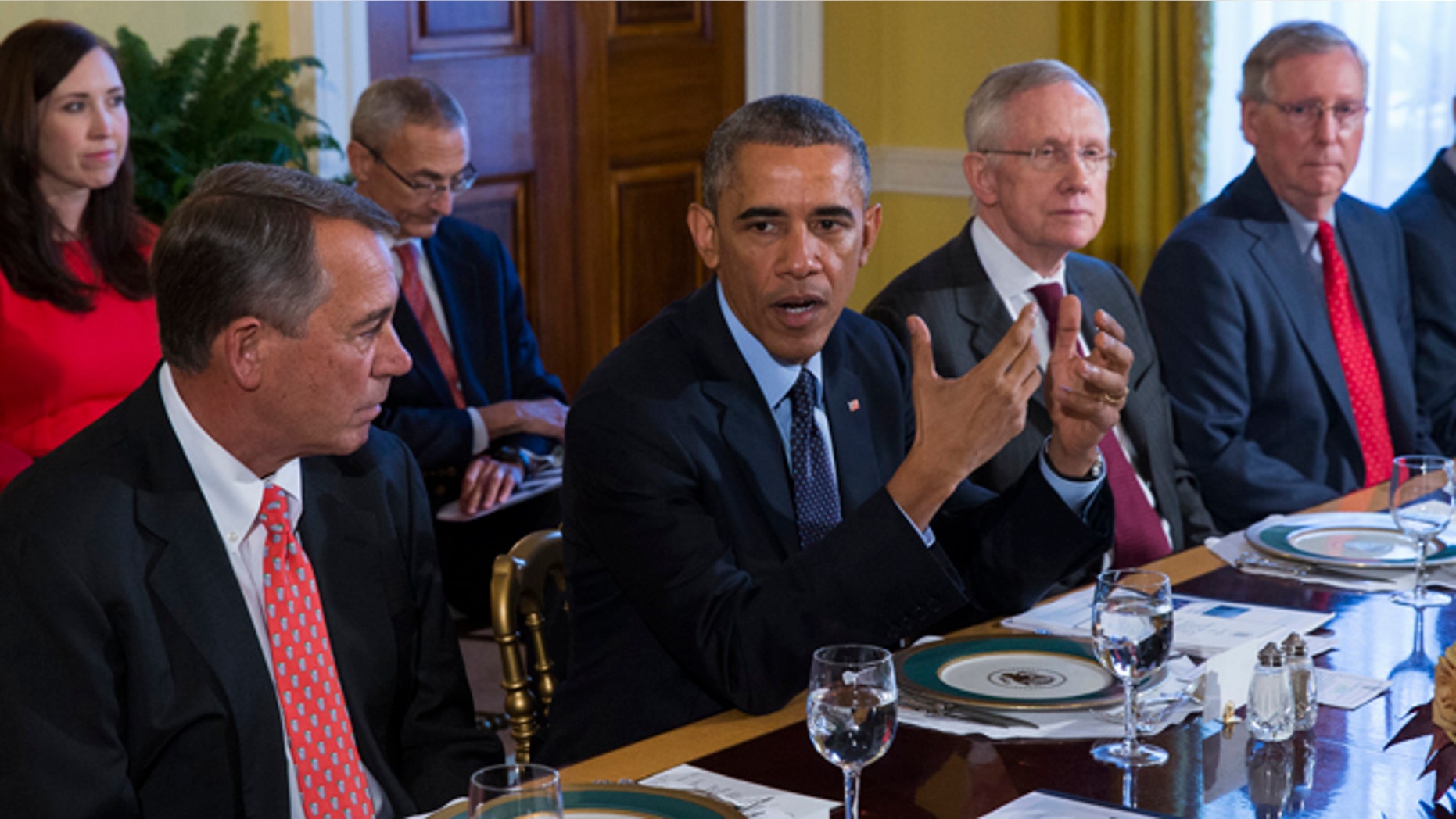 FILE - In this Nov. 7, 2014 file photo, President Barack Obama meets with Congressional leaders in the Old Family Dining Room of the White House in Washington. From left are, House Speaker John Boehner of Ohio, Obama, Senate Majority Leader Harry Reid of Nev., and Senate Minority Leader Mitch McConnell of Ky. He hardly ever calls. When he does, it's all business. That's President Barack Obama's vibe with top Democrats on Capitol Hill. With Republicans, there's even less chemistry. GOP congressional leaders don't show much inclination to buddy up to the president, either. (AP Photo/Evan Vucci, File)