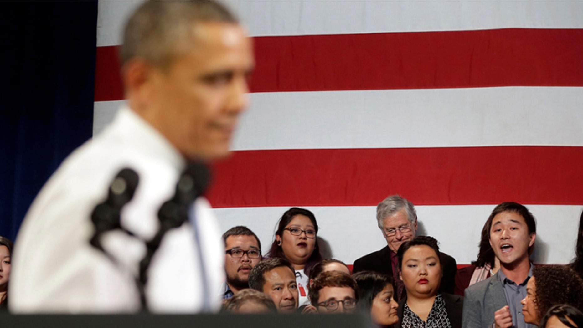 In this Nov. 25, 2013, photo, President Barack Obama, left, stops his speech and turns around in response to an unidentified man, right, who heckled him about anti-deportation policies, at the Betty Ann Ong Chinese Recreation Center in San Francisco. Obama stopped his speech about immigration reform to let this man, who was located directly behind Obama, speak and would respond to his questions. Advocates are frustrated with the failure of House Republicans to tackle immigration. Increasingly, theyâre focus is on President Barack Obama. The outside groups are demanding that Obama use his powers as chief executive to stop deportations or provide some relief to many of the 11 million immigrants living here illegally. (AP Photo/Pablo Martinez Monsivais, File)
