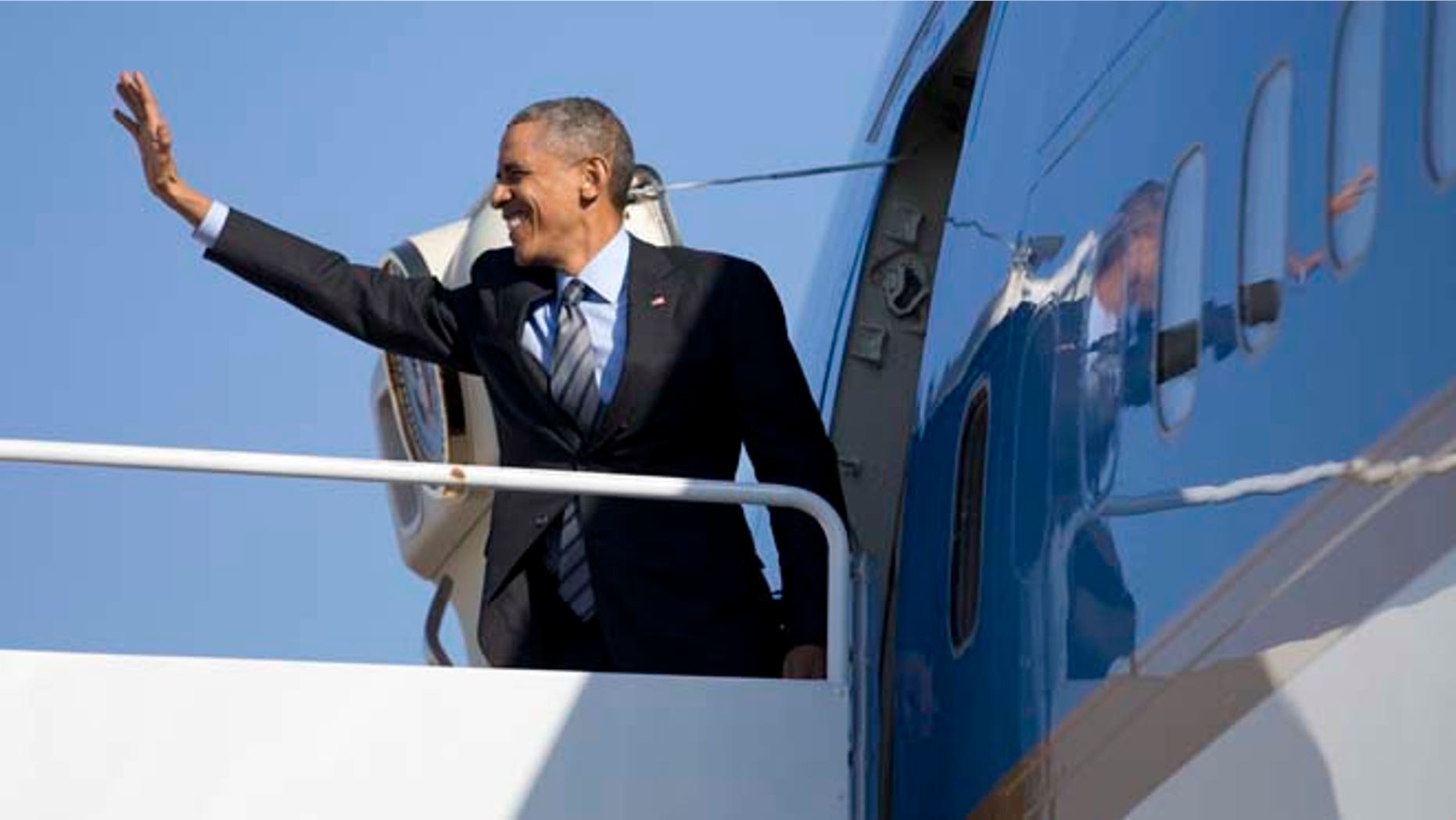 In this Friday, Nov. 21, 2014 photo, President Barack Obama boards Air Force One at Andrews Air Force Base, Md., en route to Las Vegas, where he will speak at Del Sol High School about the steps he will be taking on immigration.