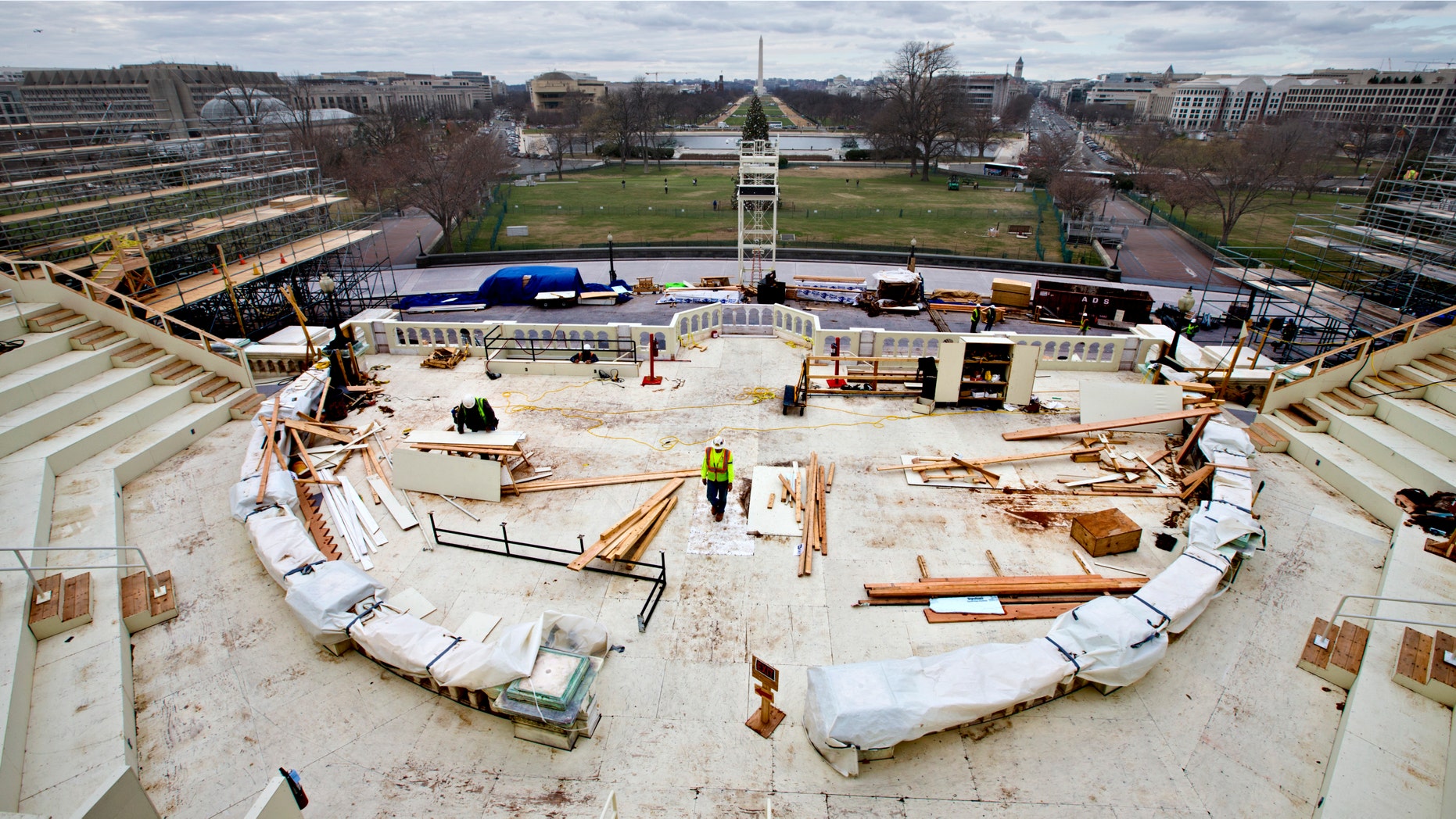 In this Dec. 11, 2012 file photo, construction workers continue work on the platforms on the west side of the Capitol where dignitaries and news cameras will witness the inaugural ceremonies on Capitol Hill in Washington. (AP Photo/J. Scott Applewhite, File)