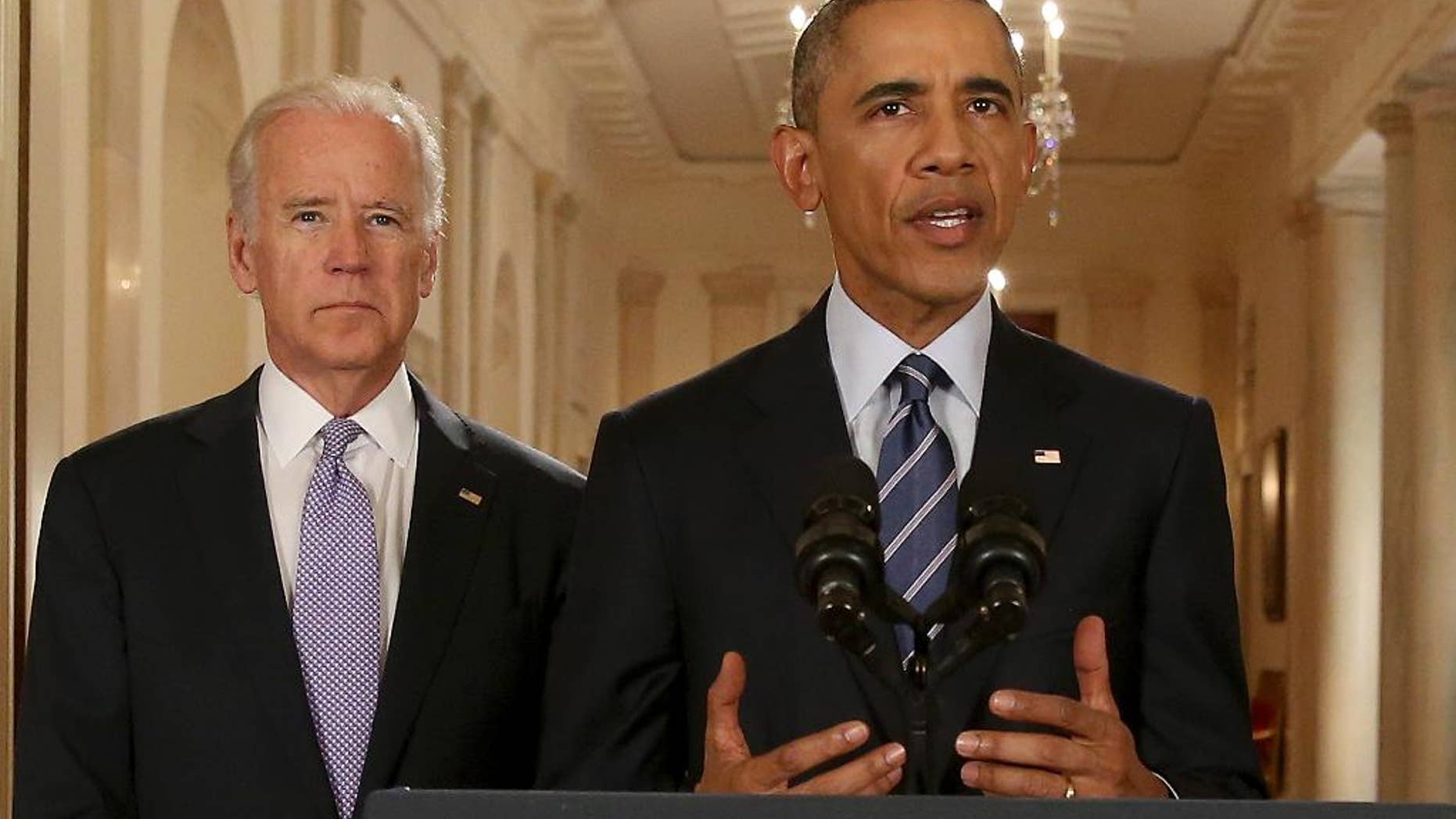 President Barack Obama, standing with Vice President Joe Biden, delivers remarks in the East Room of the White House in Washington, Tuesday, July 14, 2015, after an Iran nuclear deal is reached. After 18 days of intense and often fractious negotiation, diplomats Tuesday declared that world powers and Iran had struck a landmark deal to curb Iran's nuclear program in exchange for billions of dollars in relief from international sanctions. (AP Photo/Andrew Harnik, Pool)