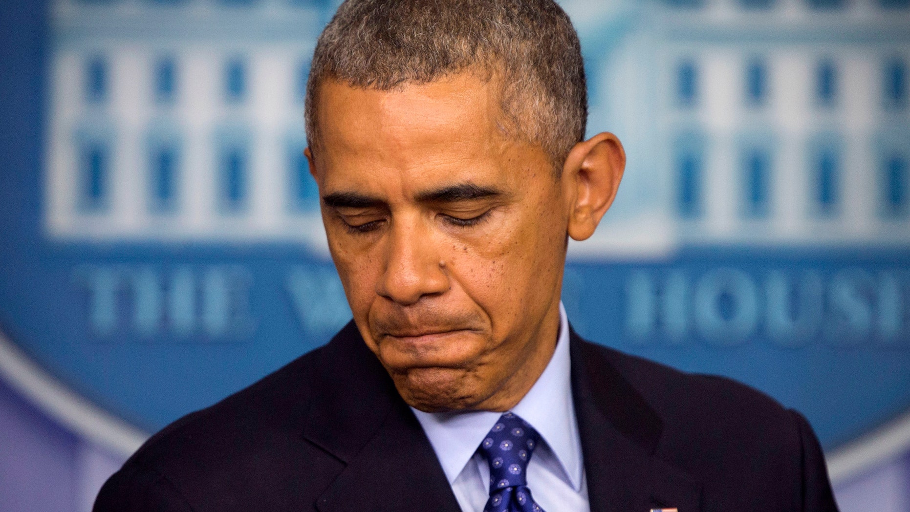 FILE - This June 19, 2014, file photo shows President Barack Obama pausing as he talks will about the situation in Iraq at the White House in Washington. Obama acknowledged the risks of mission creep when he outlined plans to help Iraq combat the Islamic insurgency that has made gains with lighting speed, but he pledged that the U.S. will not be "dragged back" into a lengthy conflict or become ensnarled in "mission creep." The deployments mark a sharp shift for a president who oversaw the full withdrawal of American forces from Iraq in late 2011 after Washington and Baghdad failed to reach an agreement to keep a few thousand troops in place. (AP Photo/Pablo Martinez Monsivais, File)