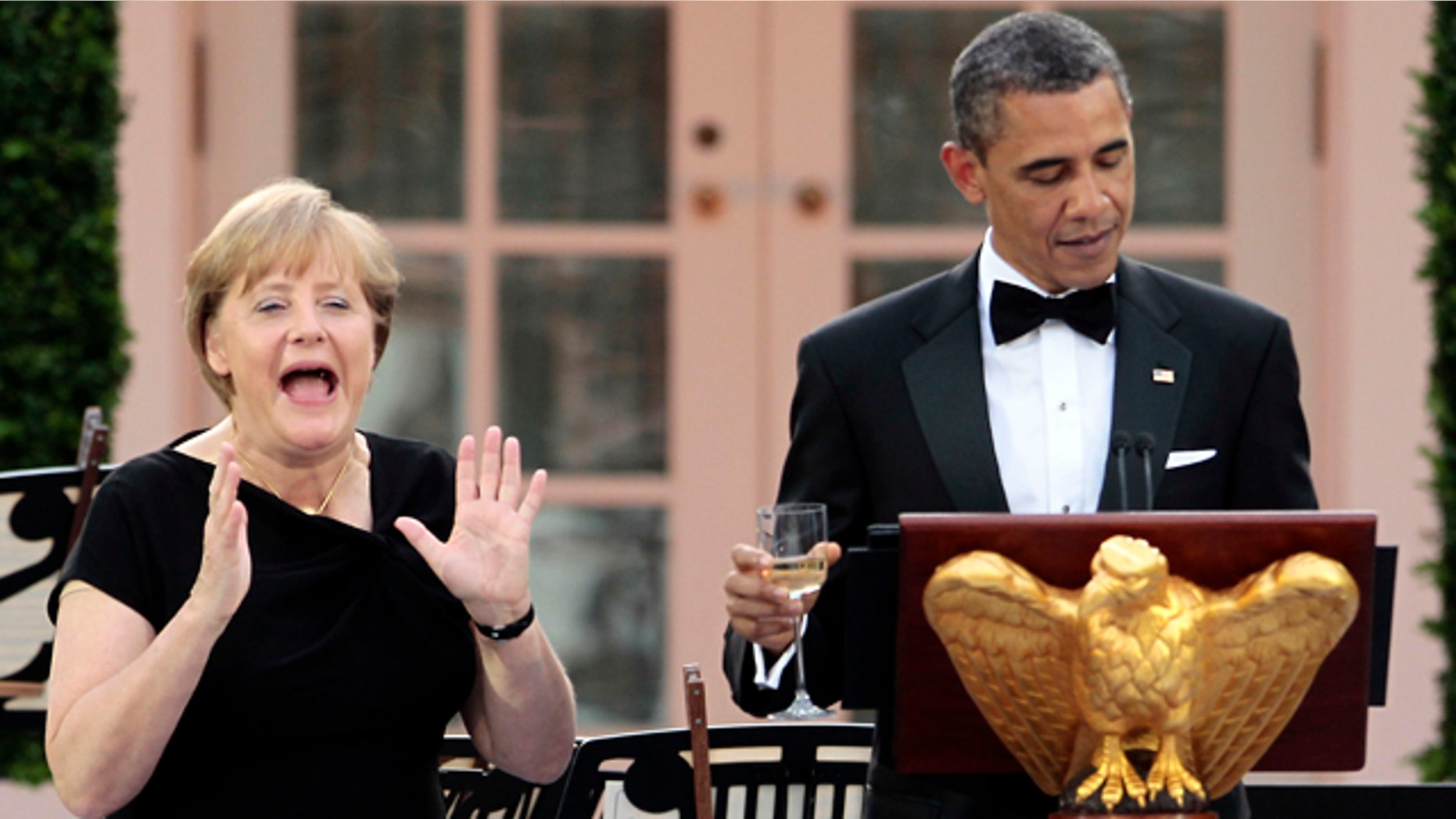 June 7: German Chancellor Angela Merkel, left, reacts as President Obama remembers to share a toast in her honor at a State Dinner in the Rose Garden of the White House in Washington.