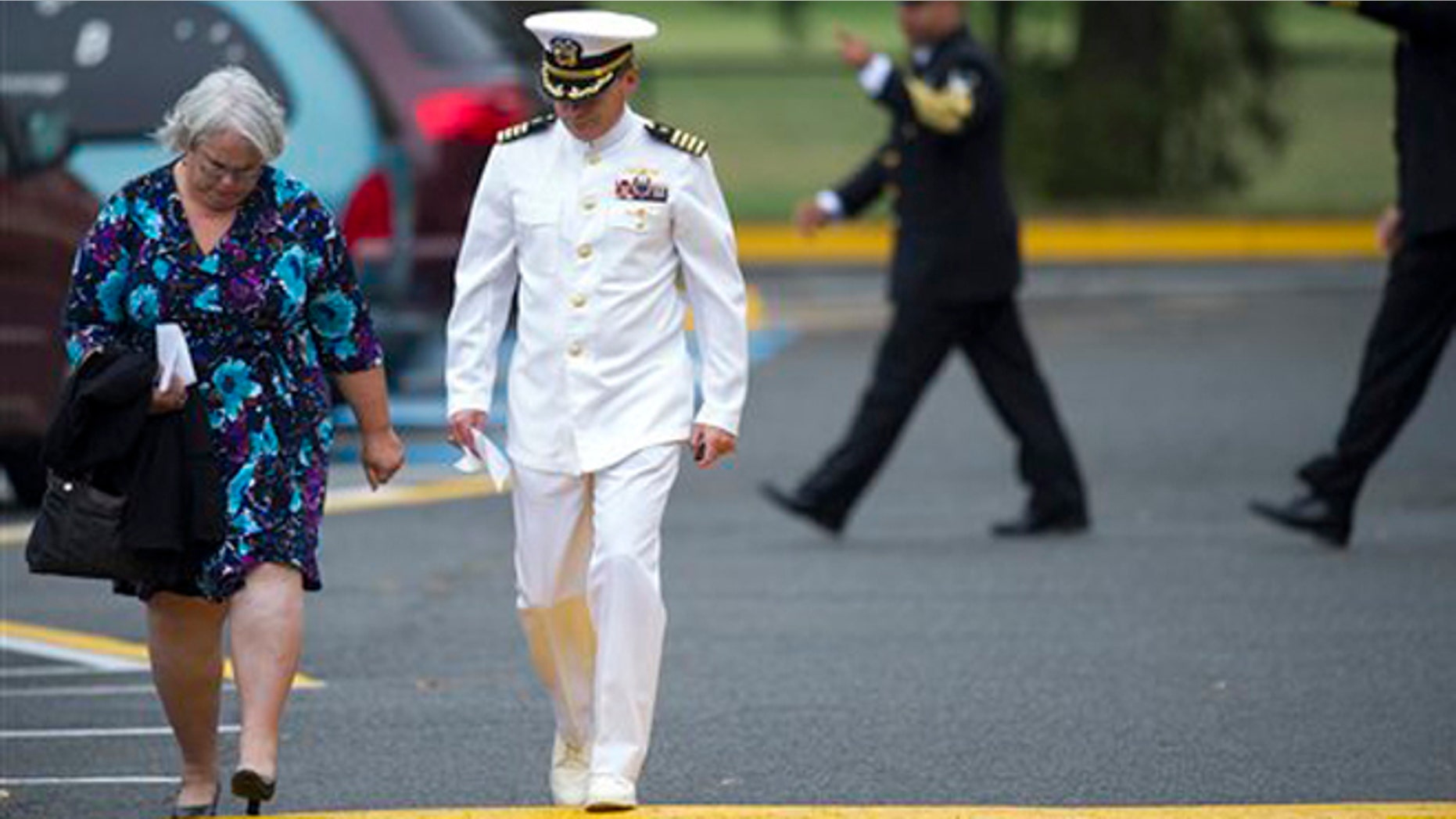 Mourners leave a funeral service for Navy Yard shooting victim Martin Bodrog, of Annandale, Va., at the Immanuel Bible Church in Springfield, Va., Saturday, Sept. 21, 2013. (AP Photo/Cliff Owen)